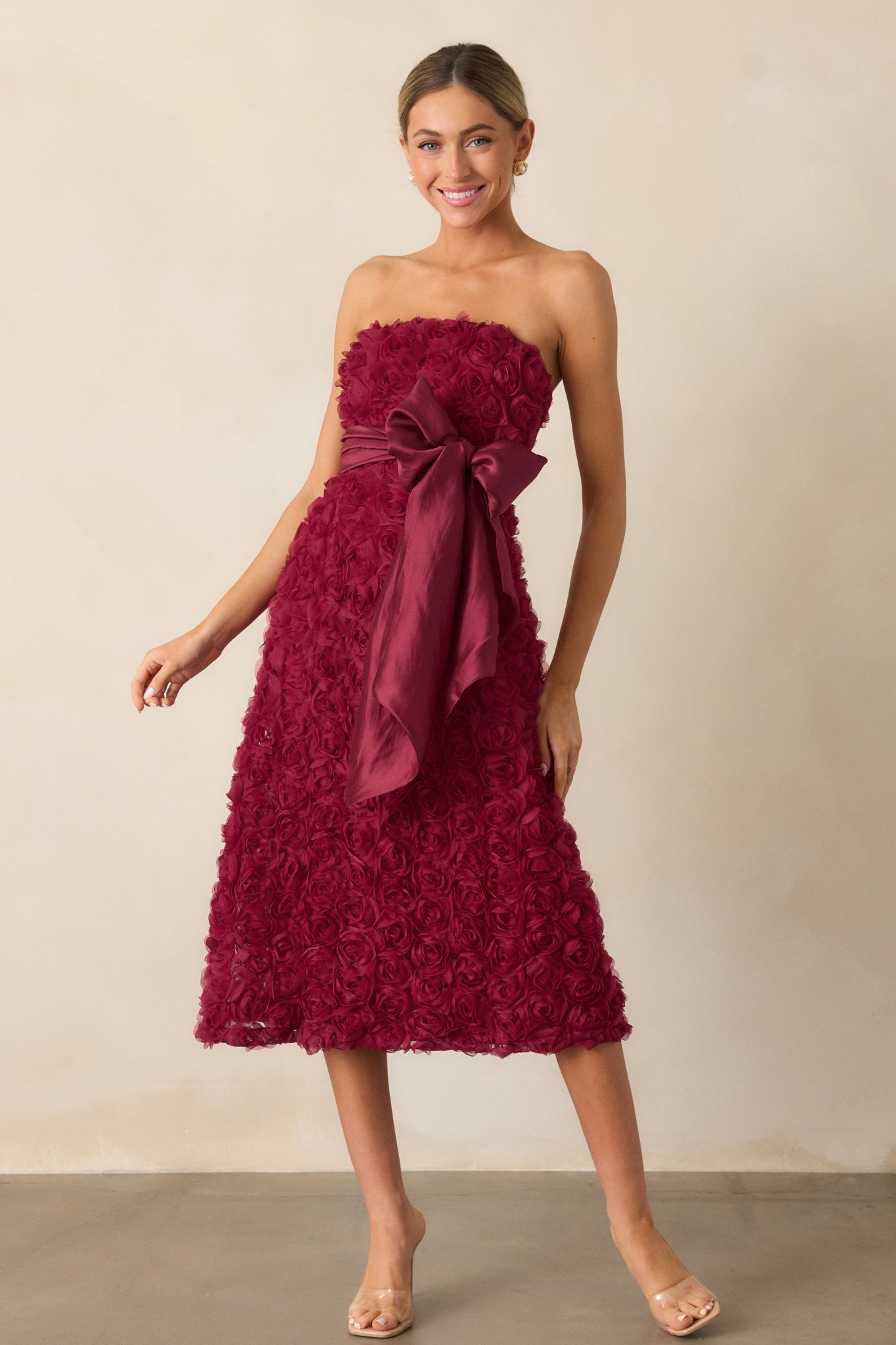 The dress is shown in its entirety, emphasizing the self-tie bow at the waist and the elegant midi-length silhouette.