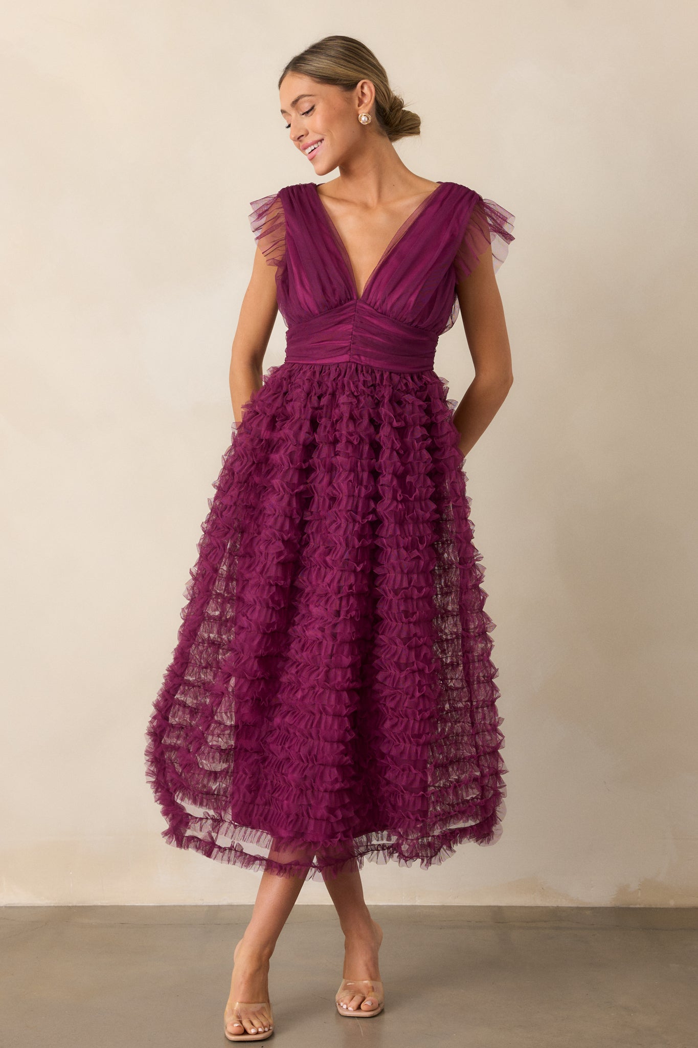 The dress is displayed from head to toe, highlighting the soft ruffle sleeve details and the flow of the tiered skirt.