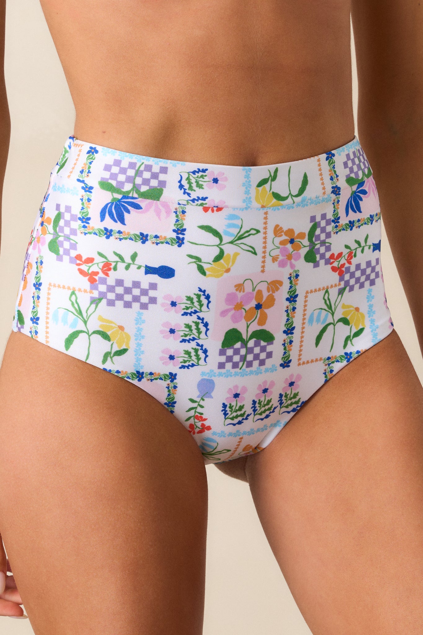 An up-close detail shot of the beautiful picnic print on the ivory bikini bottom.