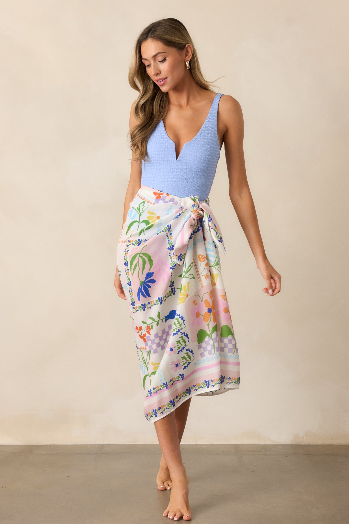 The ivory sarong in a full-length shot, featuring a vibrant picnic print and luxurious silky texture.