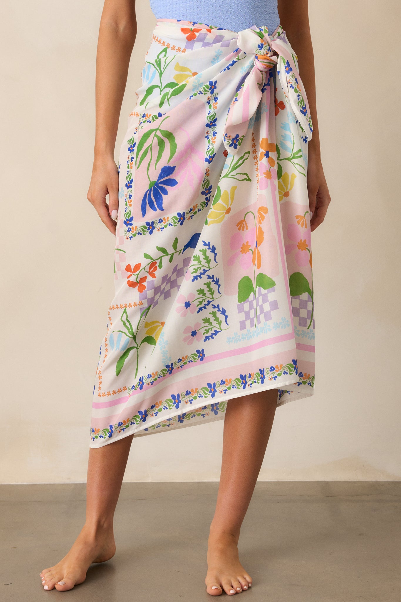 "Detailed view of the elegant picnic print and smooth texture of the ivory sarong.