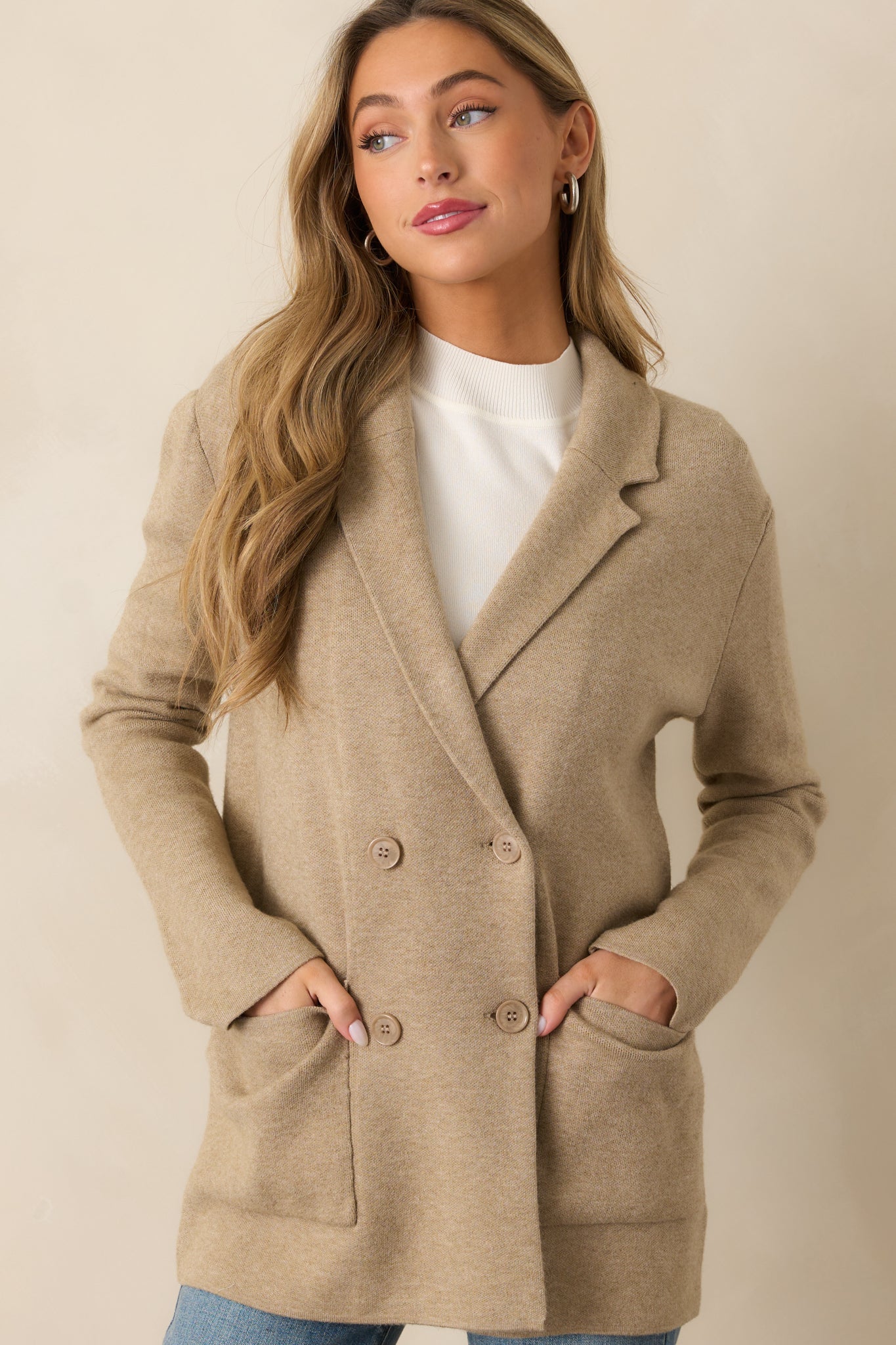 A close view of the button front and knit texture of the oatmeal heather blazer, highlighting its refined yet soft design.