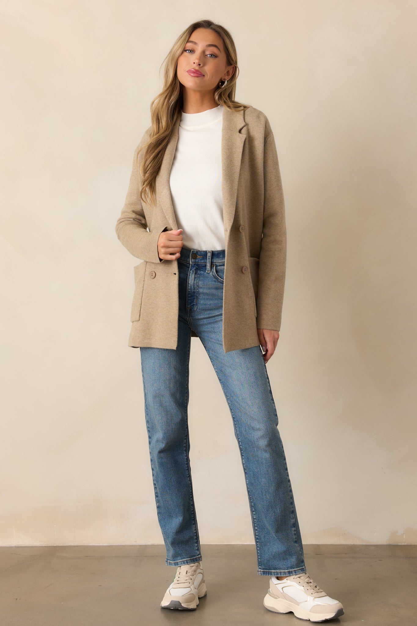 An oatmeal heather blazer with a collared neckline, soft knit fabric, button front, and functional pockets, offering a polished yet cozy look.