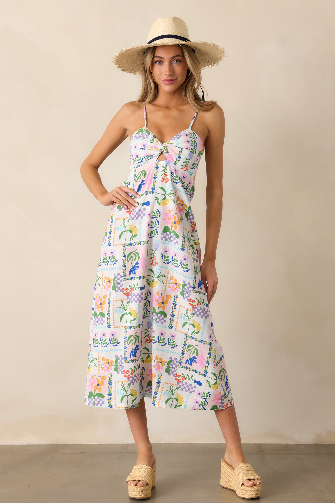 Full display of the ivory dress featuring a twist neckline, colorful picnic pattern, and relaxed silhouette.