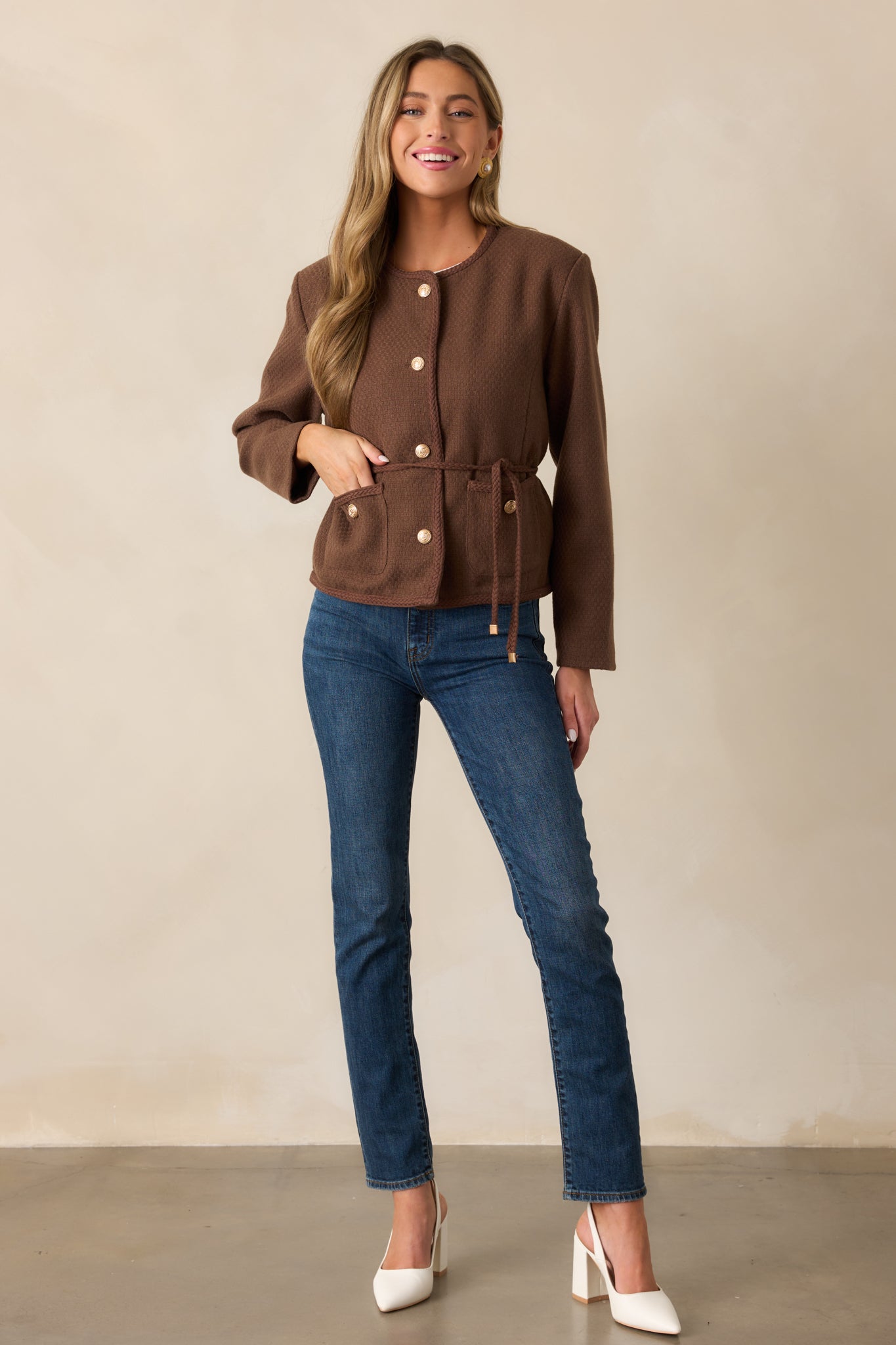 Full-length view of a chocolate brown jacket featuring a tailored design, tweed-style fabric, round neckline, and braided trim.