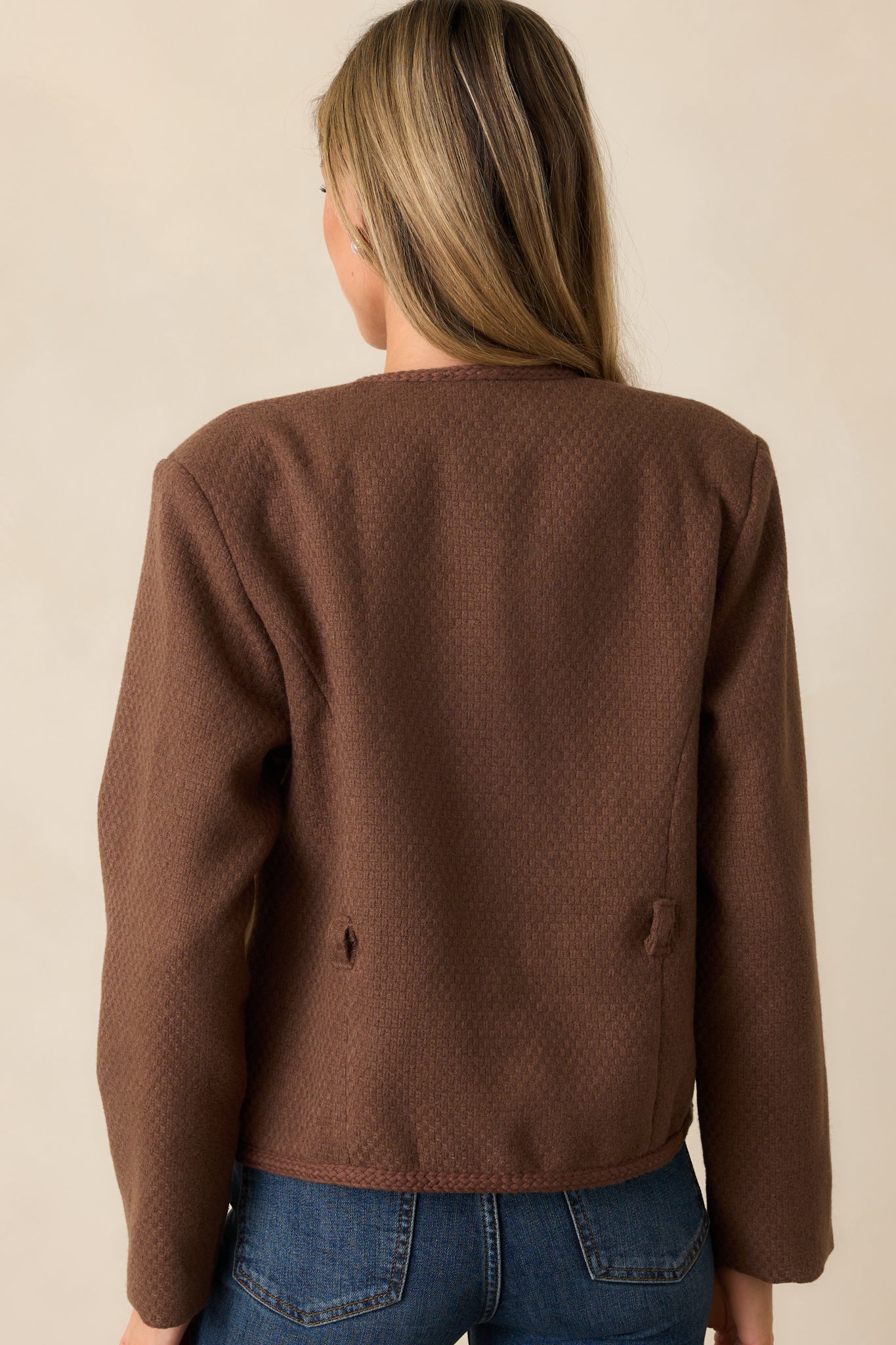 Back view of the chocolate brown jacket highlighting the tailored fit, tweed fabric, and braided trim running along the edges.