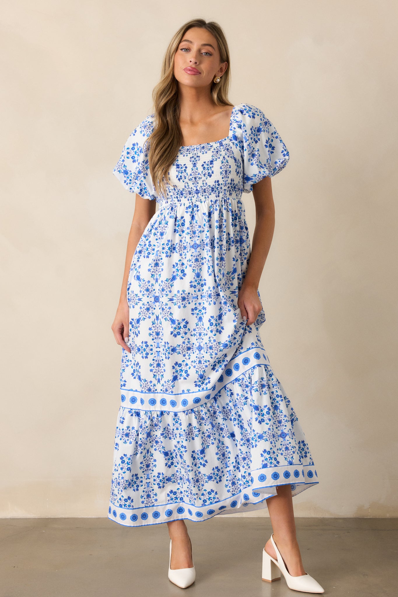 A full-length view of the royal blue maxi dress, showcasing its square neckline, floral pattern, and relaxed skirt.