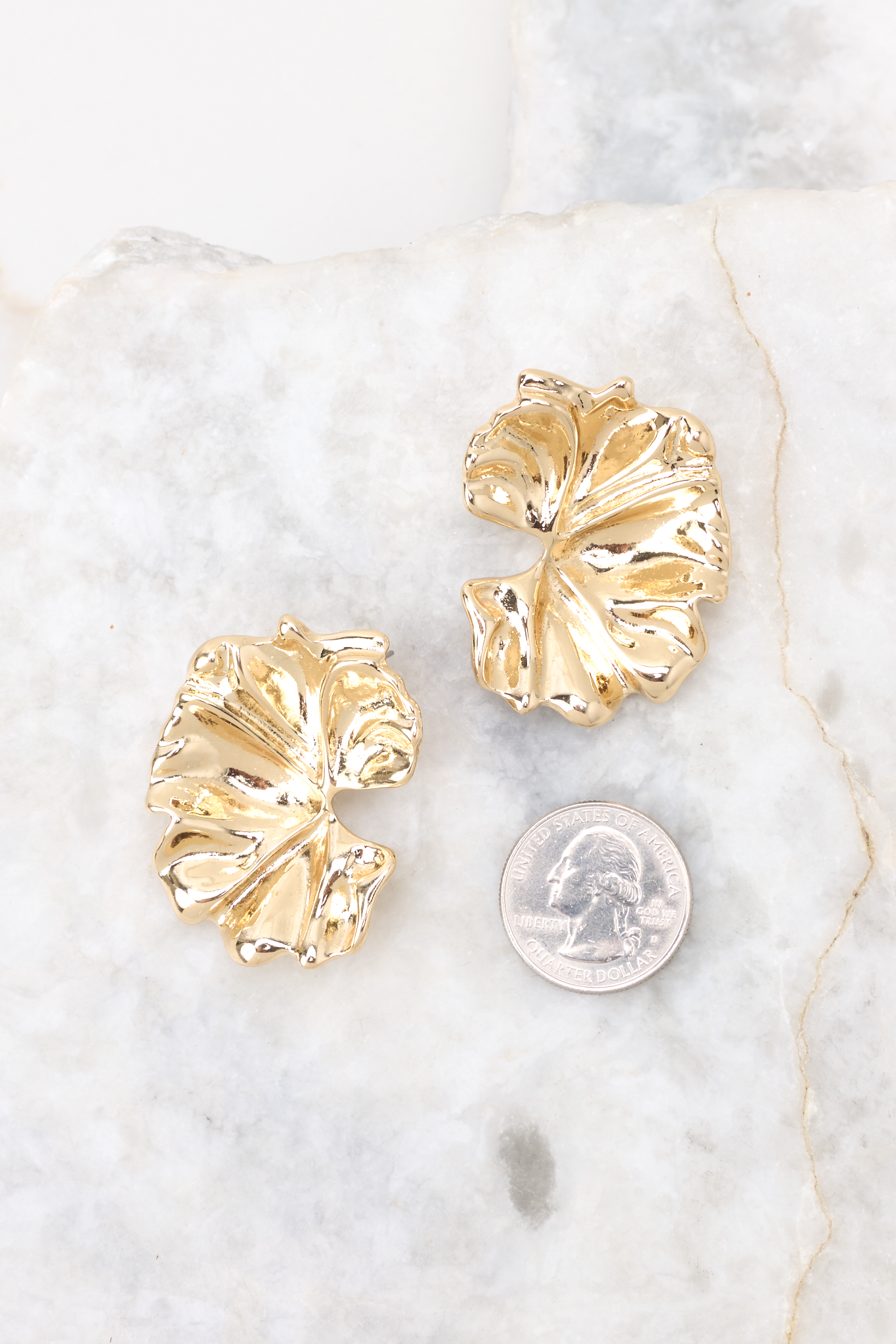 Gold earrings compared to quarter for actual size. Earrings measure 1.5" in diameter. 