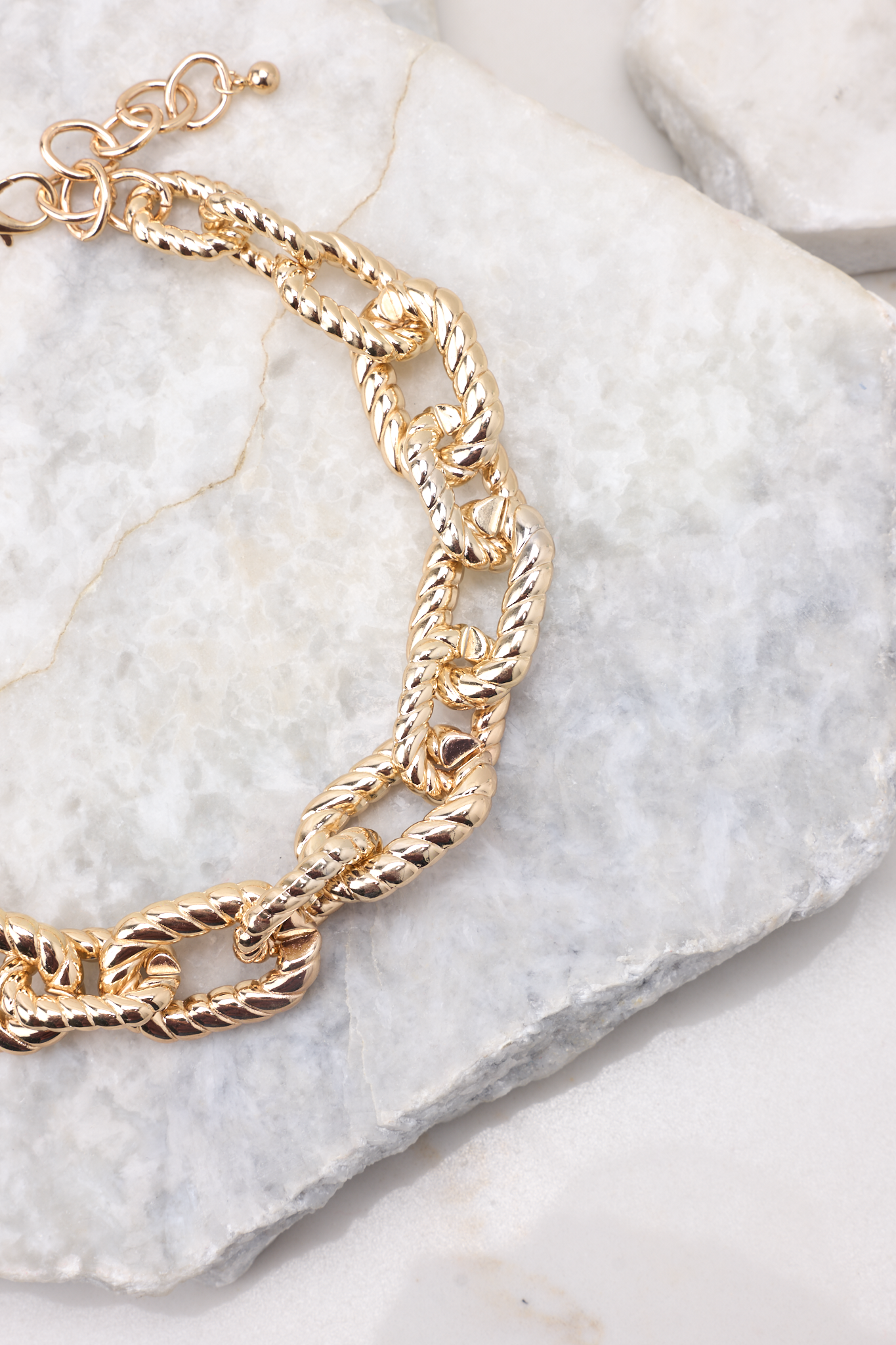 Detailed shot necklace that features large gold chain link pattern and measures 10". 