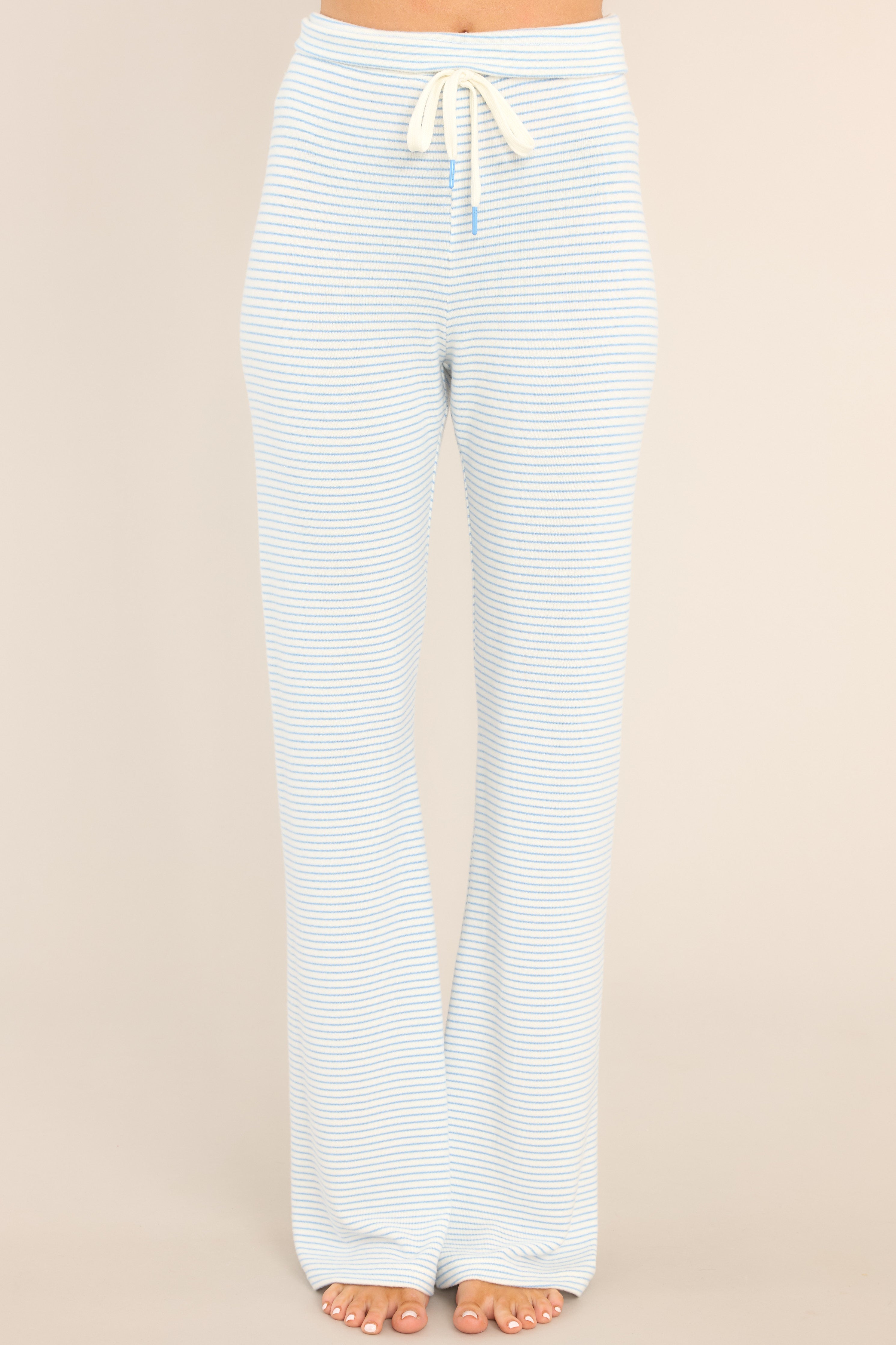 Front view of Z Supply blue and white  horizontally striped lounge pants with an elastic waistband and tie.