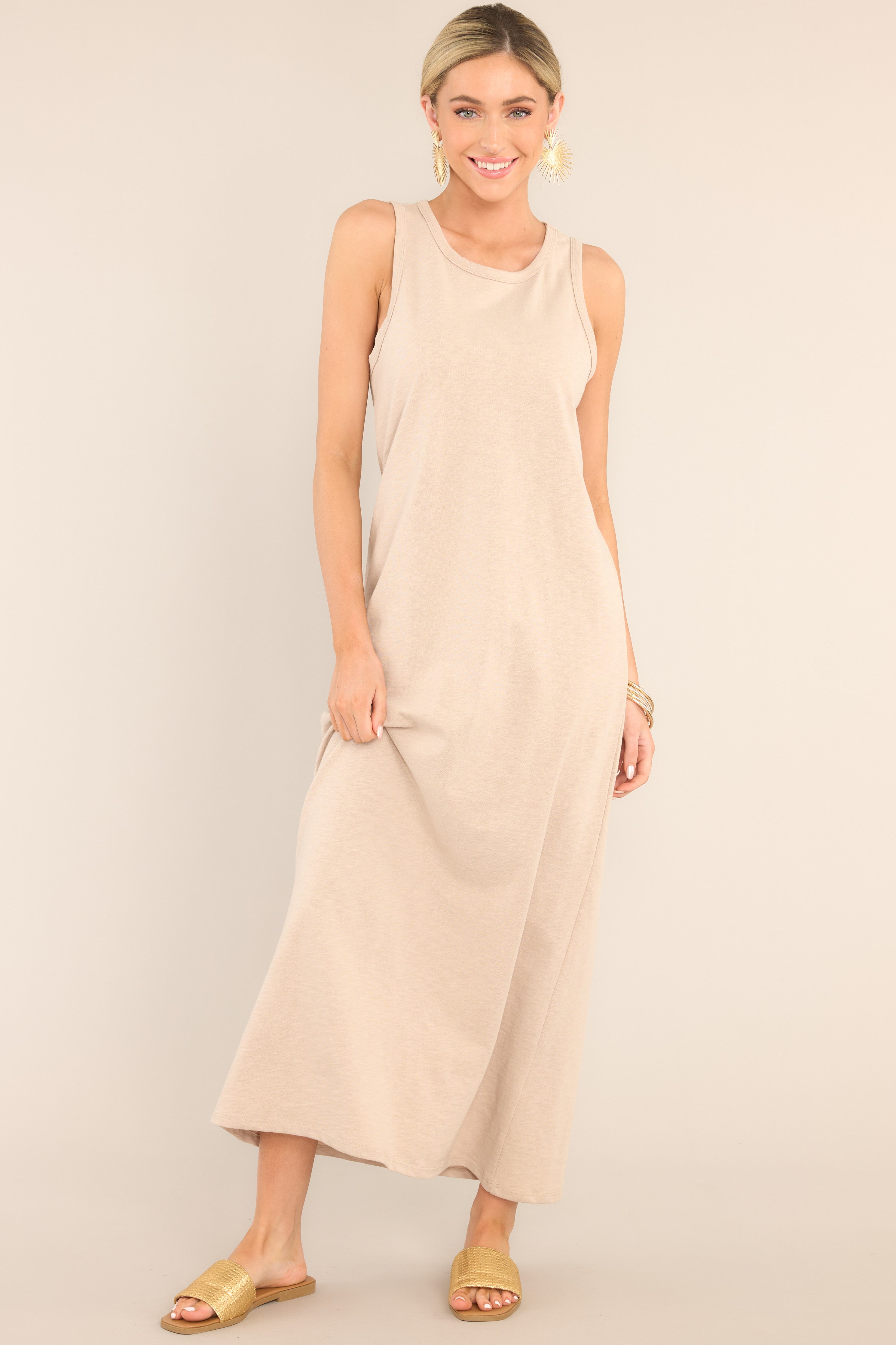 Full body view of  this dress that features a crew neckline, a straight silhouette, and a slightly stretchy cotton material that gives it a relaxed fit.