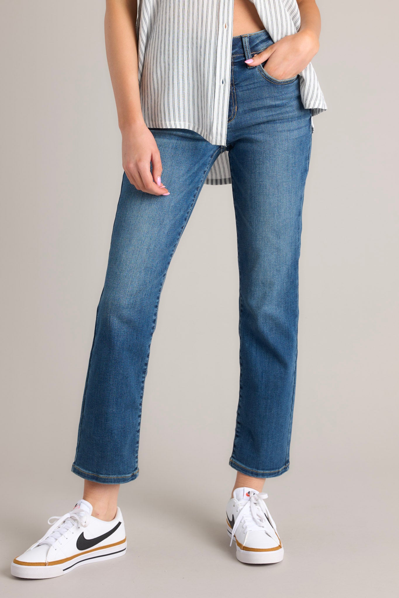 Front view of these jeans that feature a zipper and button closure, belt loops, 5 functional pockets, and a straight leg design.