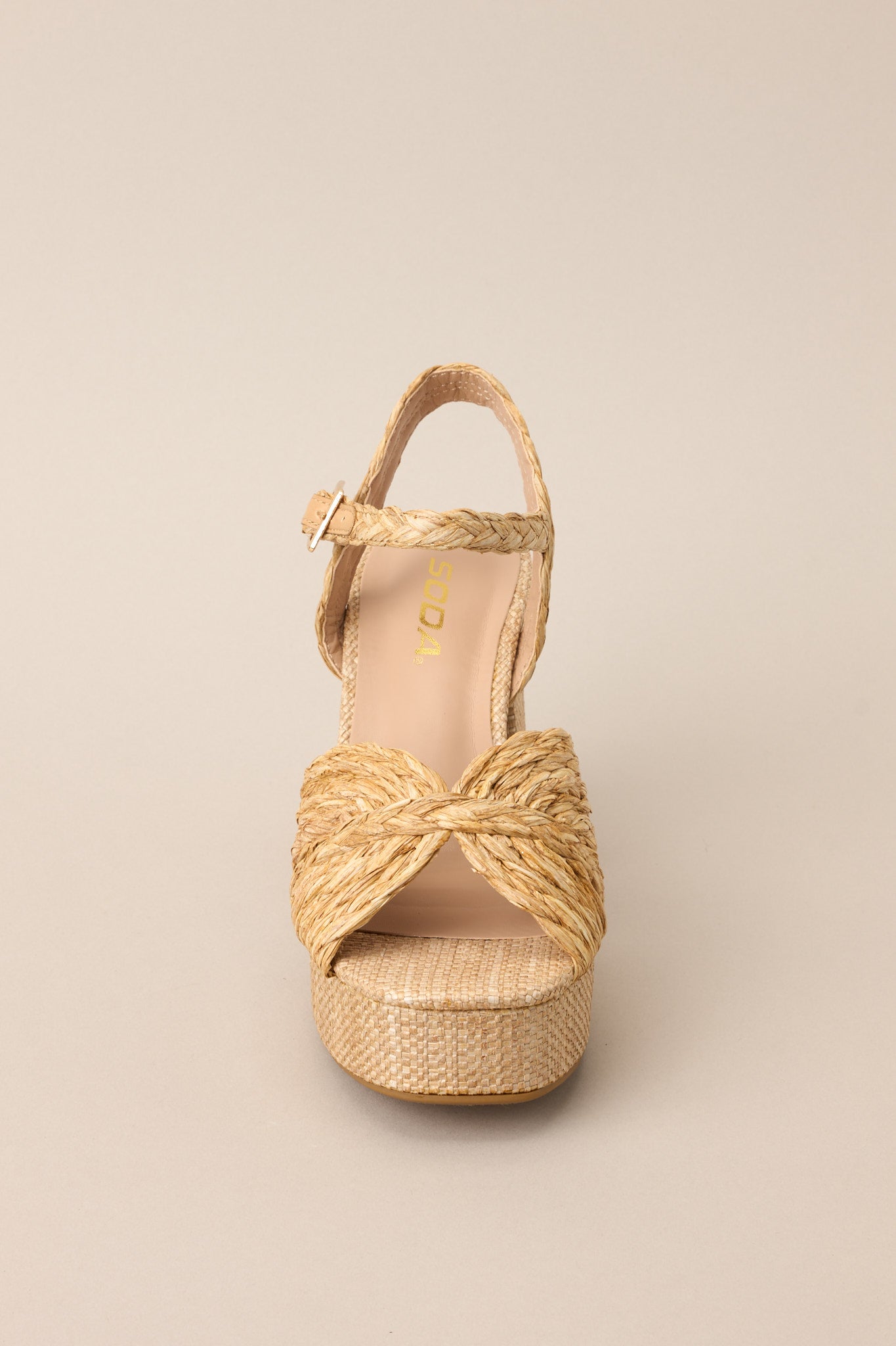 Front view of these sandals that feature a wide strap over the top of the foot, a strap around the ankle with a classic buckle closure, a platform, and a chunky heel.