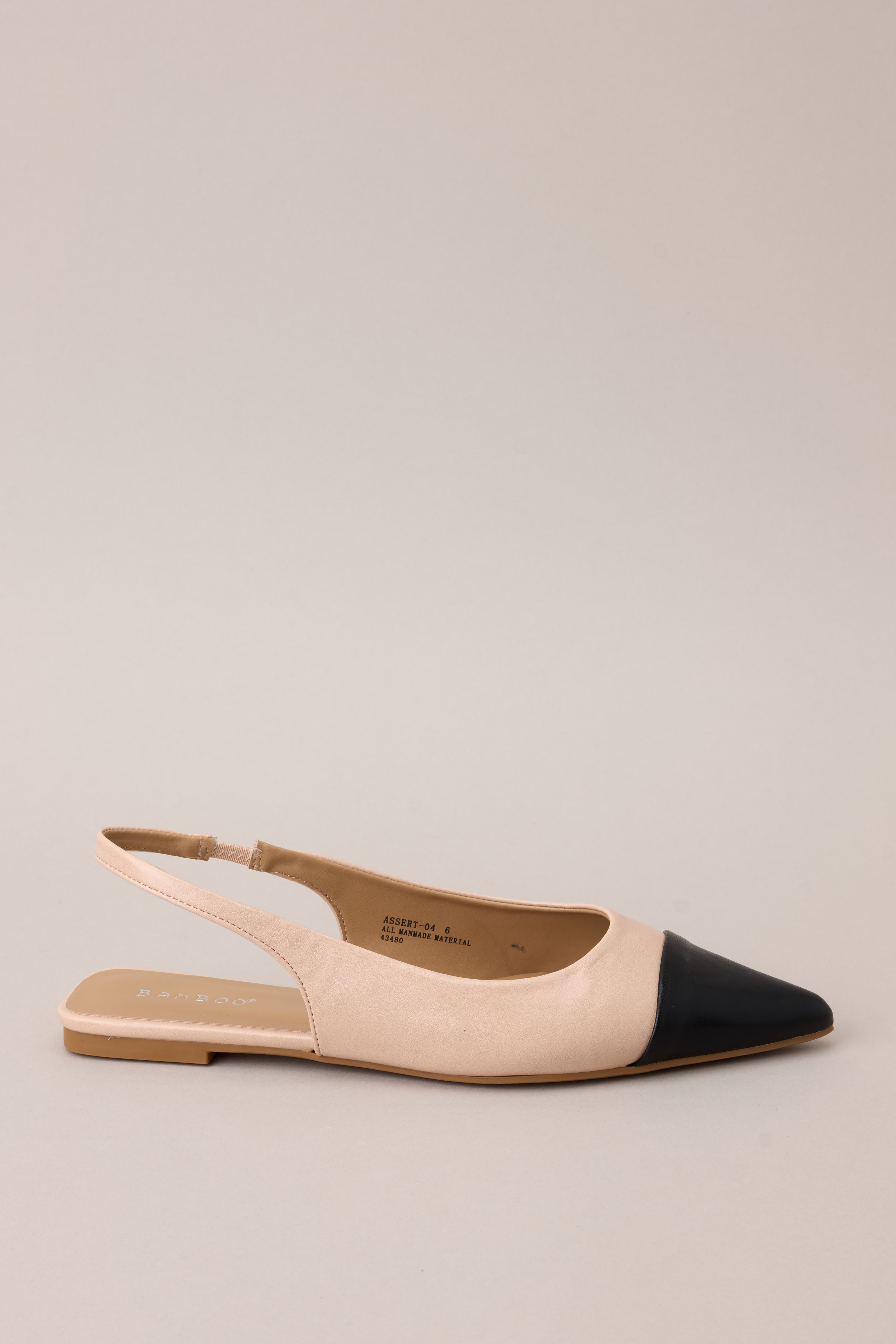 Full side view of these flats that feature a pointed toe, a color block design, and non adjustable strap.