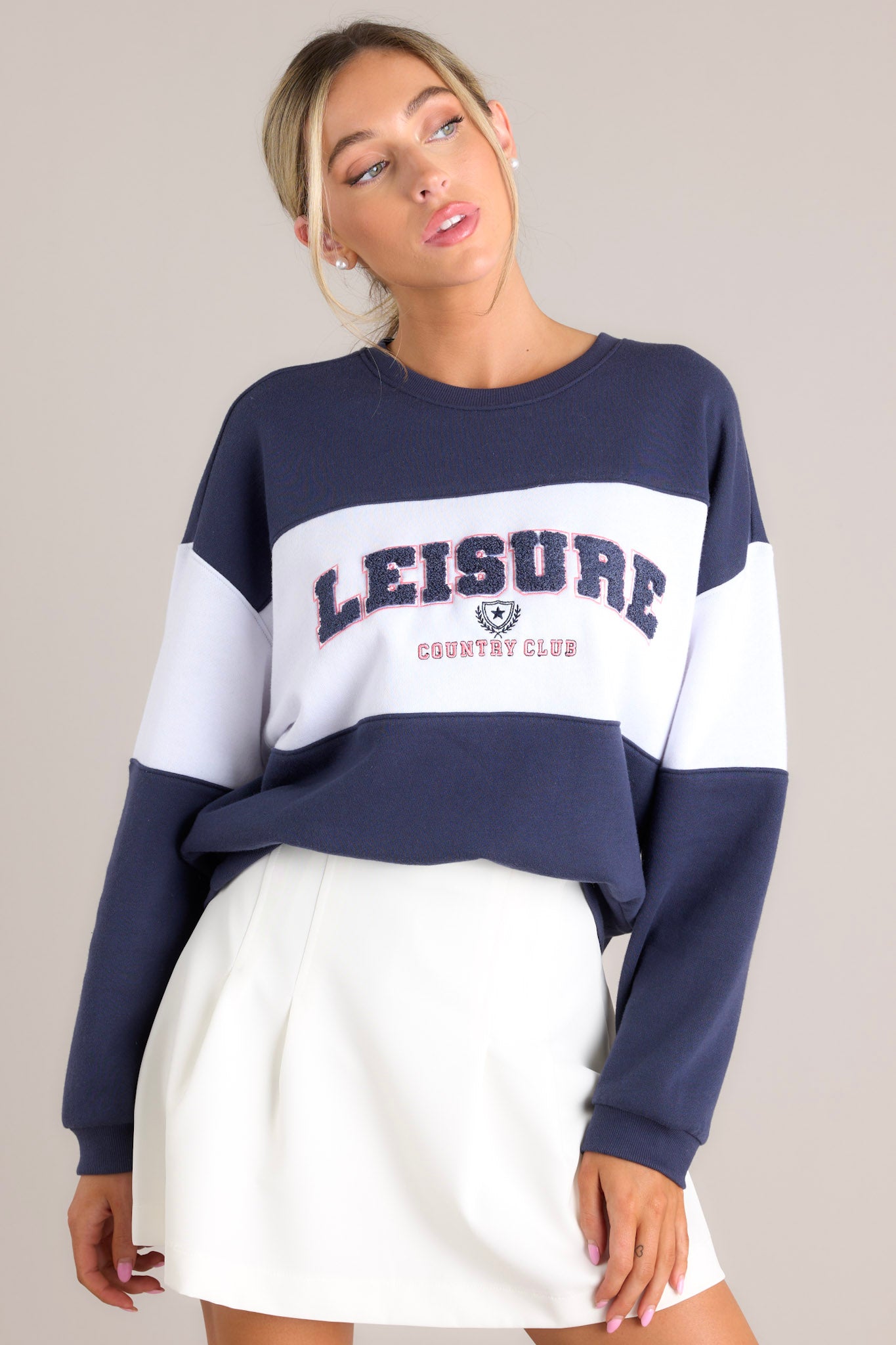 Front view of this sweatshirt that features a ribbed crew neckline, high contrast color blocking, embroidered & terry cloth wording, ribbed cuffed sleeves, and a ribbed hemline.