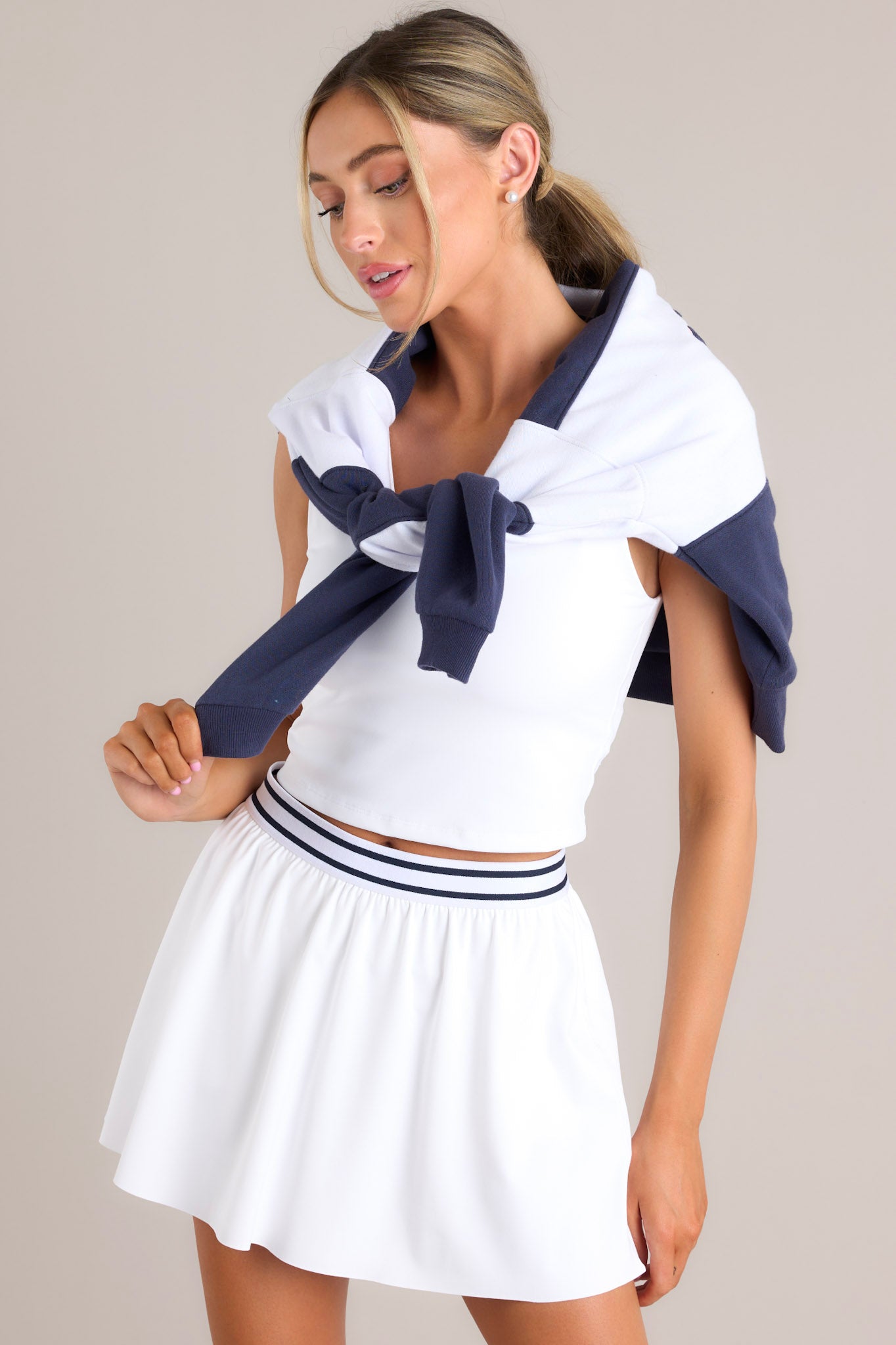 Front view of this skirt that feature a high waisted design, an elastic waistband, built-in shorts, with functional pockets, and a flowing skirt.