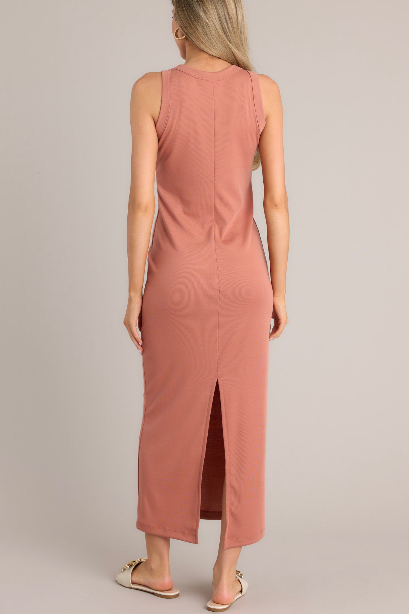 Back view of this terracotta dress with a scoop neckline, a slit in the back, and made from super soft material.