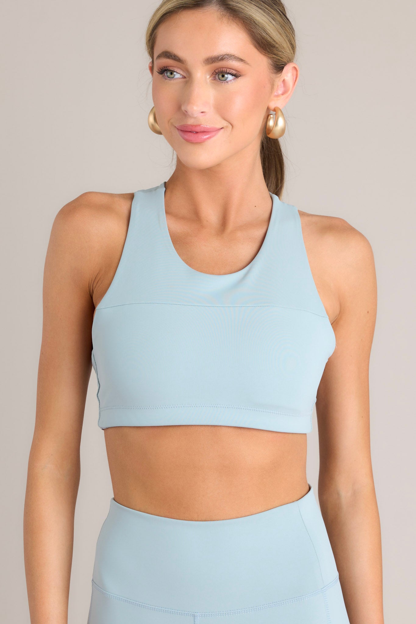 Front view of this sports bra that features a high neckline and removable pads.