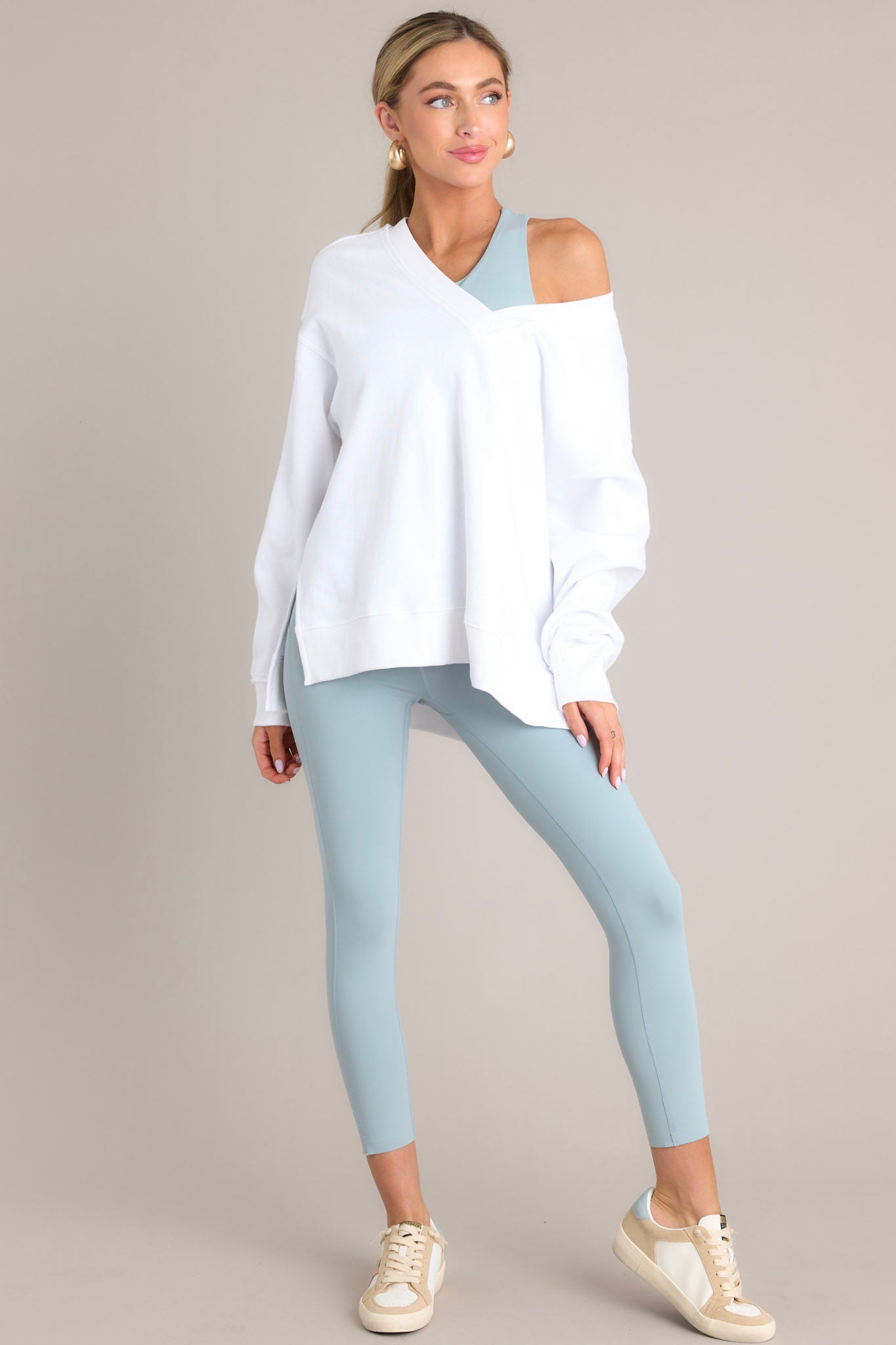 Full body view of this sweatshirt that features a v-neckline, a soft material, a split hemline, and ribbed cuffed sleeves.