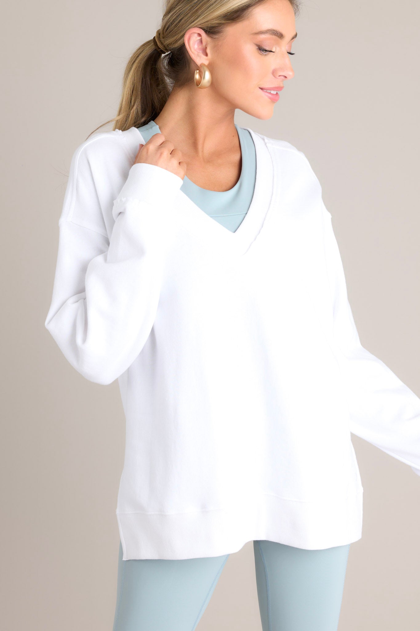 Front view of this sweatshirt that features a v-neckline, a soft material, a split hemline, and ribbed cuffed sleeves.