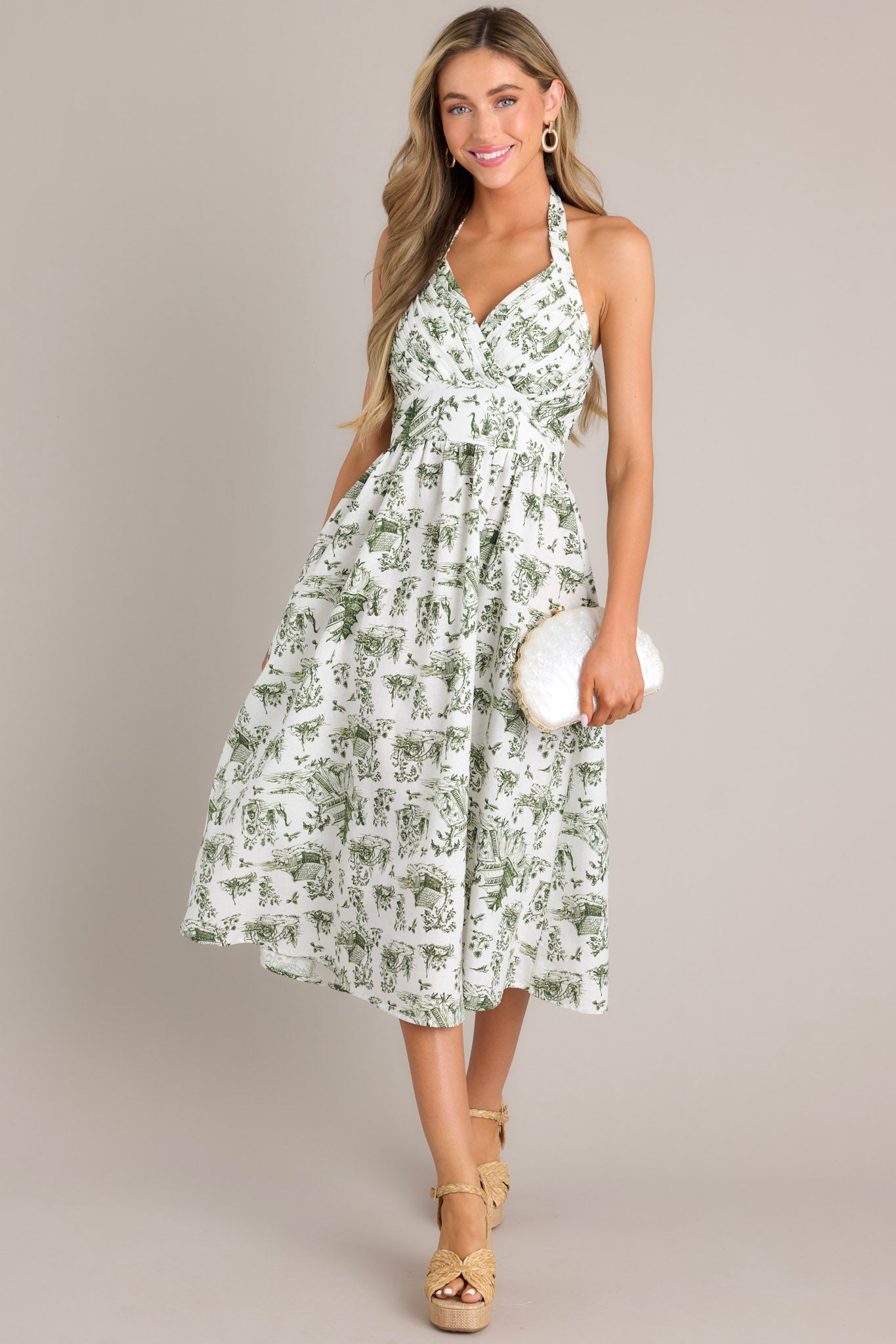 Full body view of this dress that features a self-tie halter neckline, a fully smocked back, a pleated chest, a thick waistband, and a lightweight material.