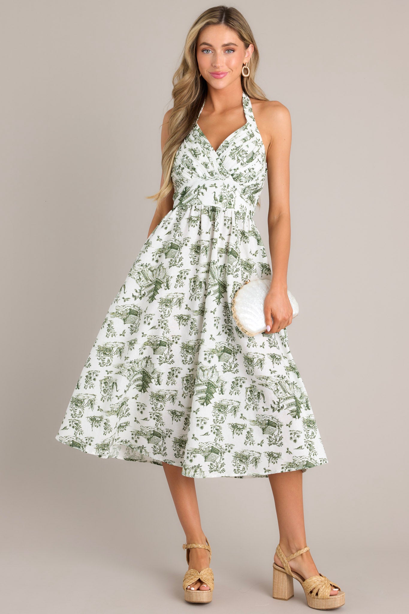 Front view of this dress that features a self-tie halter neckline, a fully smocked back, a pleated chest, a thick waistband, and a lightweight material.