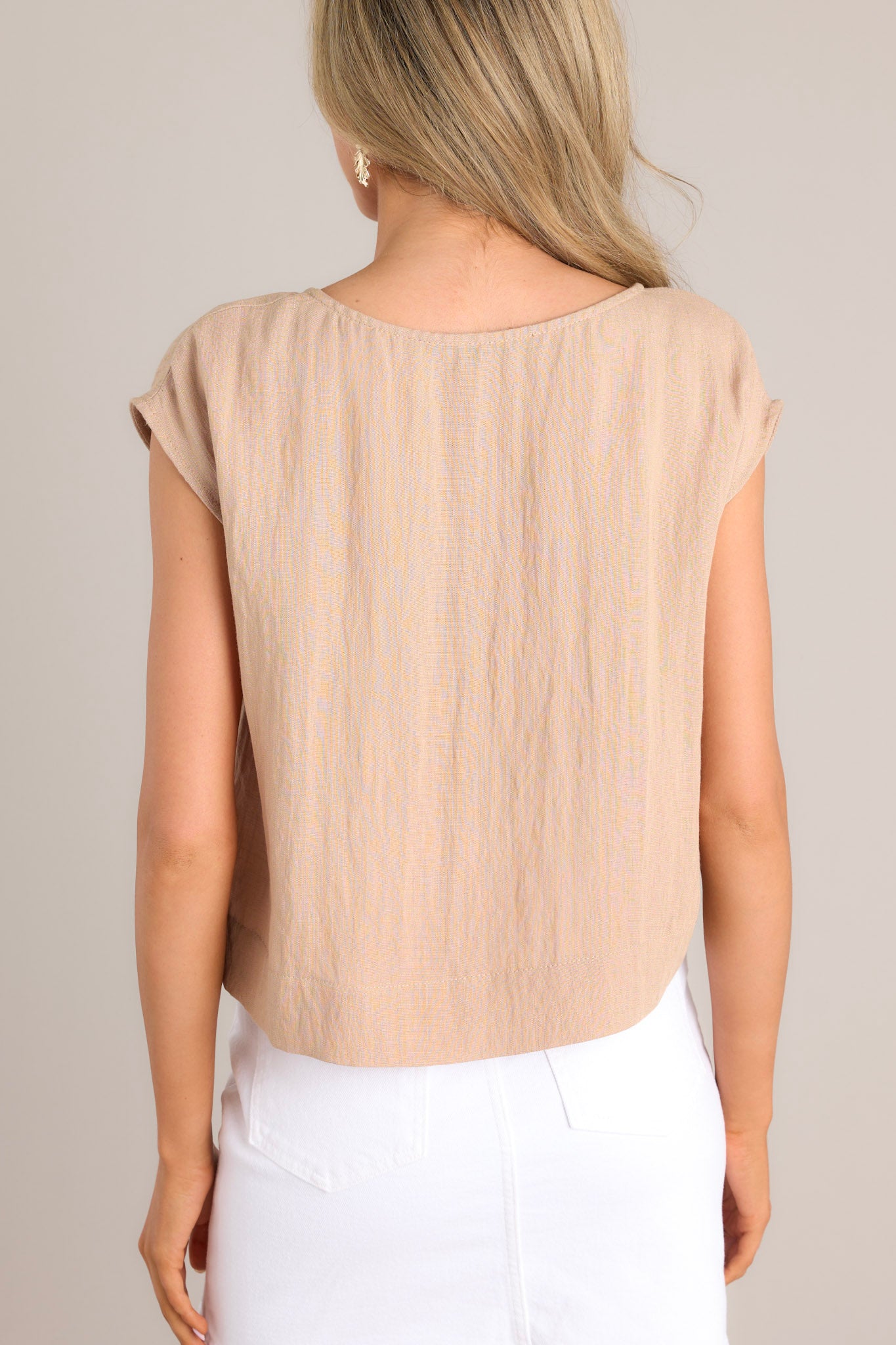 Back view of this top that features a cap sleeve design, a crew neckline, slightly cropped length, and breezy lightweight fabric.