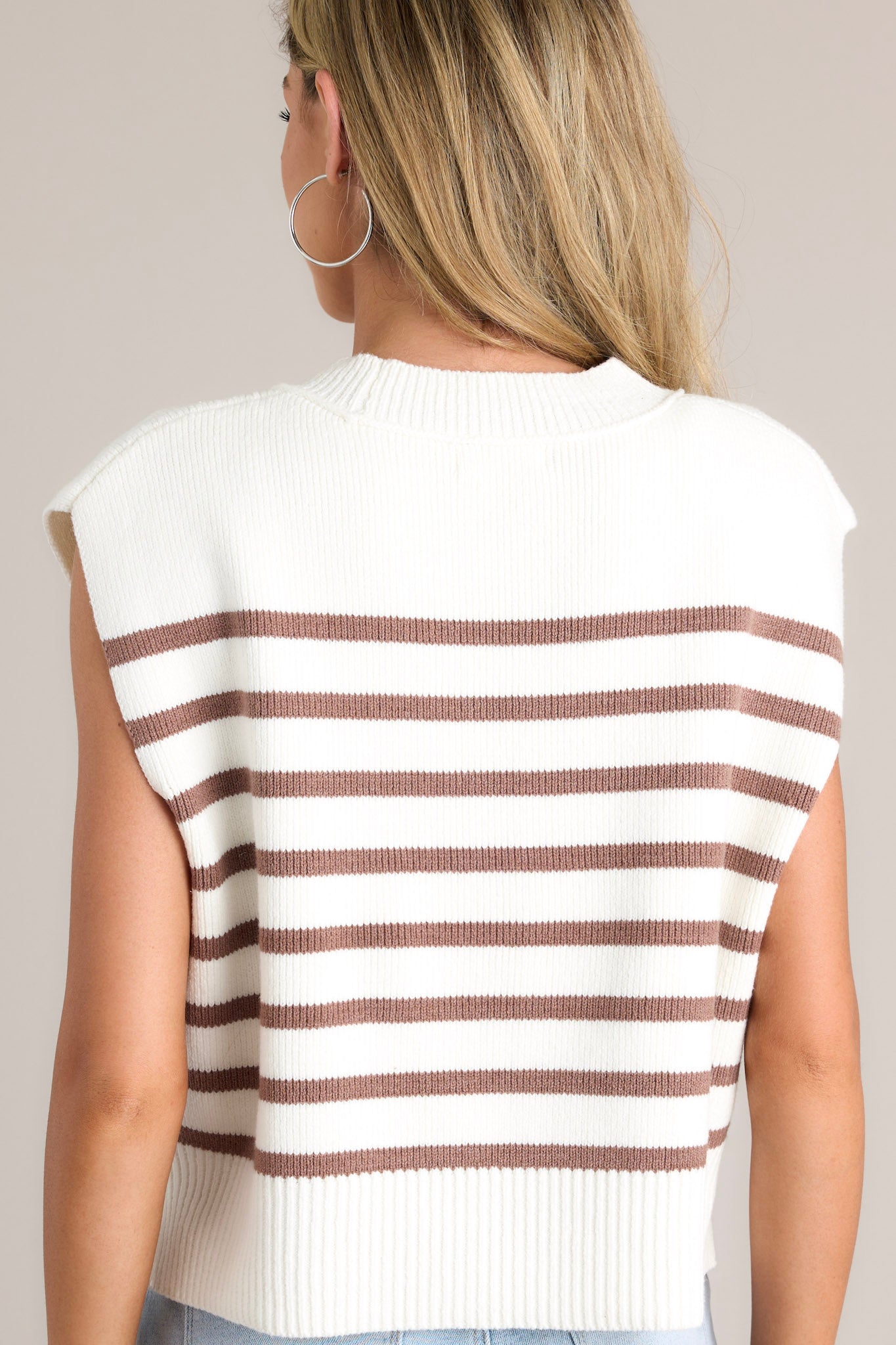 Back view of a brown stripe top highlighting the horizontal stripes and the cap sleeves.