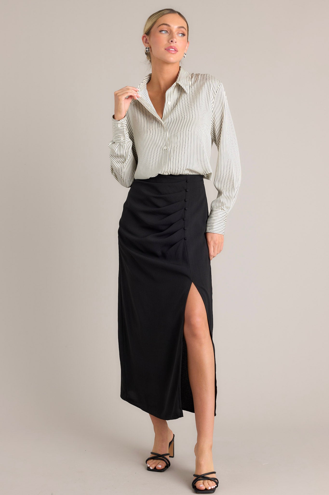 Full body front view of this white & black top that features a collared neckline, buttons down the front, buttons at the cuff, and a classic relaxed fit.