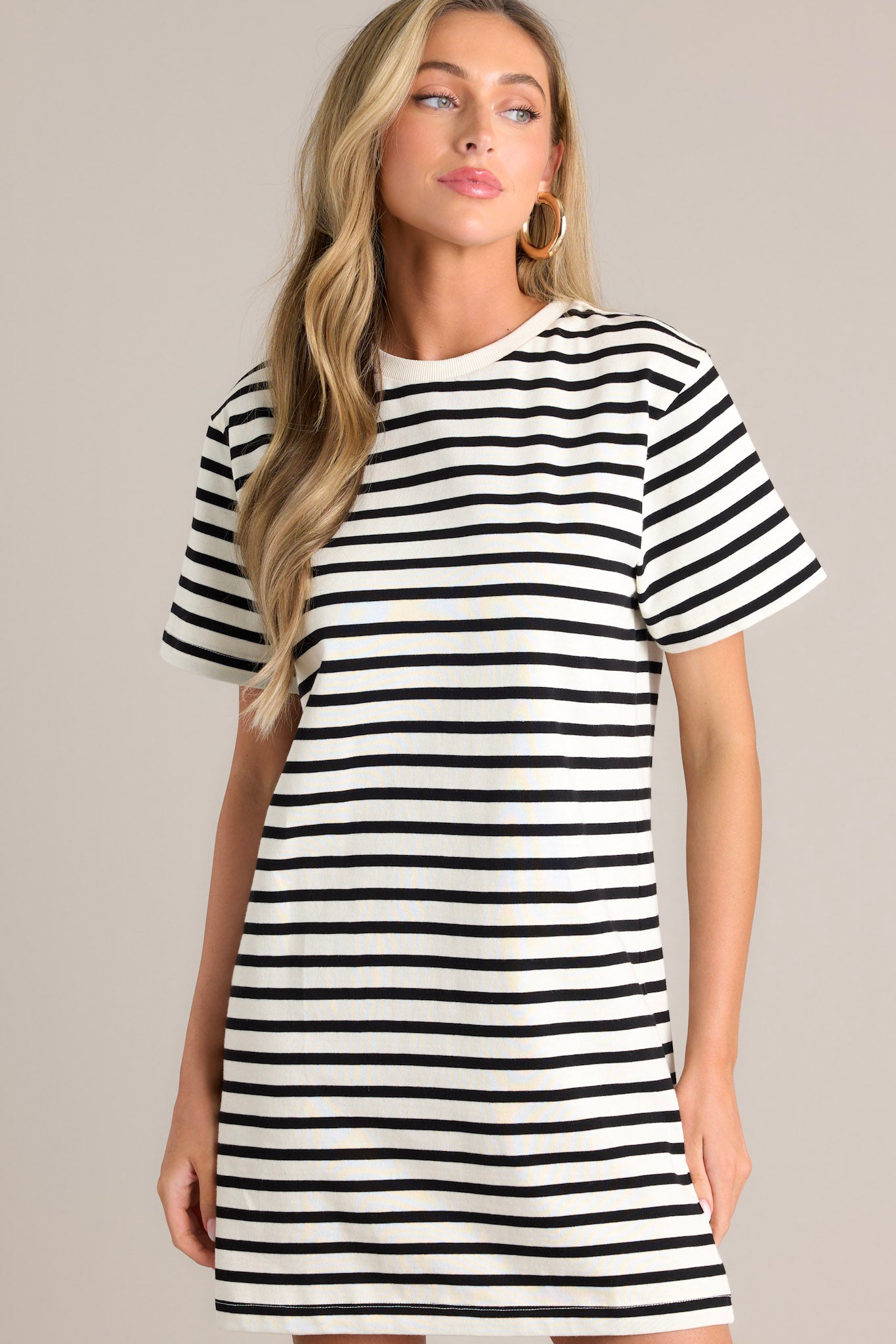 Close up front view of this white stripe mini dress that features a crew neckline, wide short sleeves, and a classic stripe pattern.