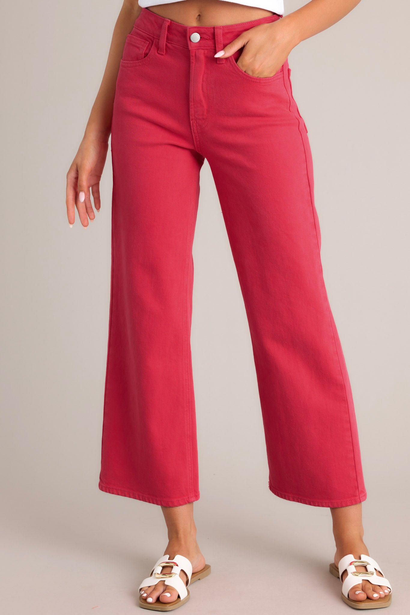 These red jeans feature a high waisted design, classic button & zipper closure, belt loops, functional front &amp; back pockets, and a cropped length.