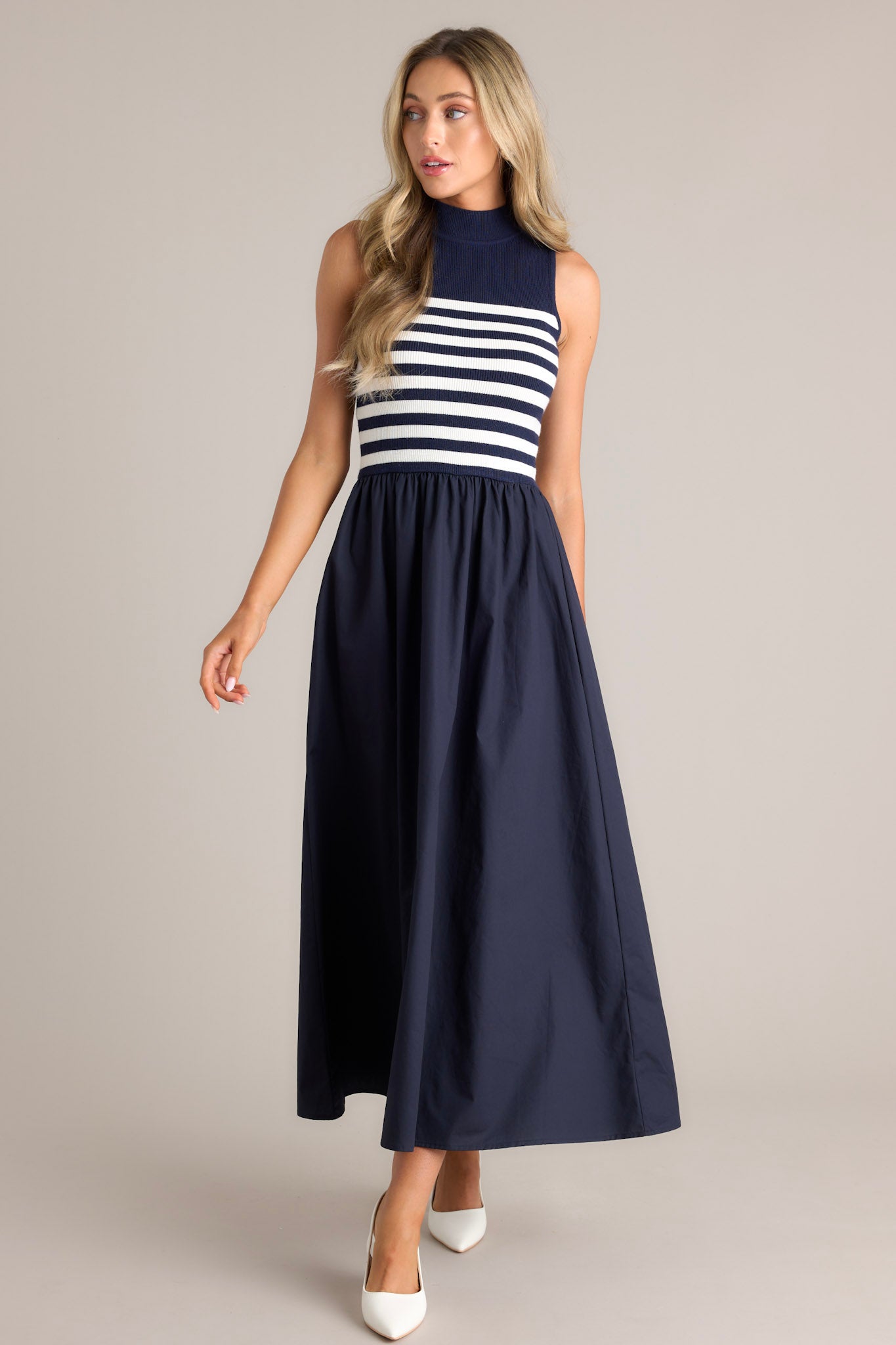 Navy dress featuring a sleeveless striped top and a solid full-length skirt.