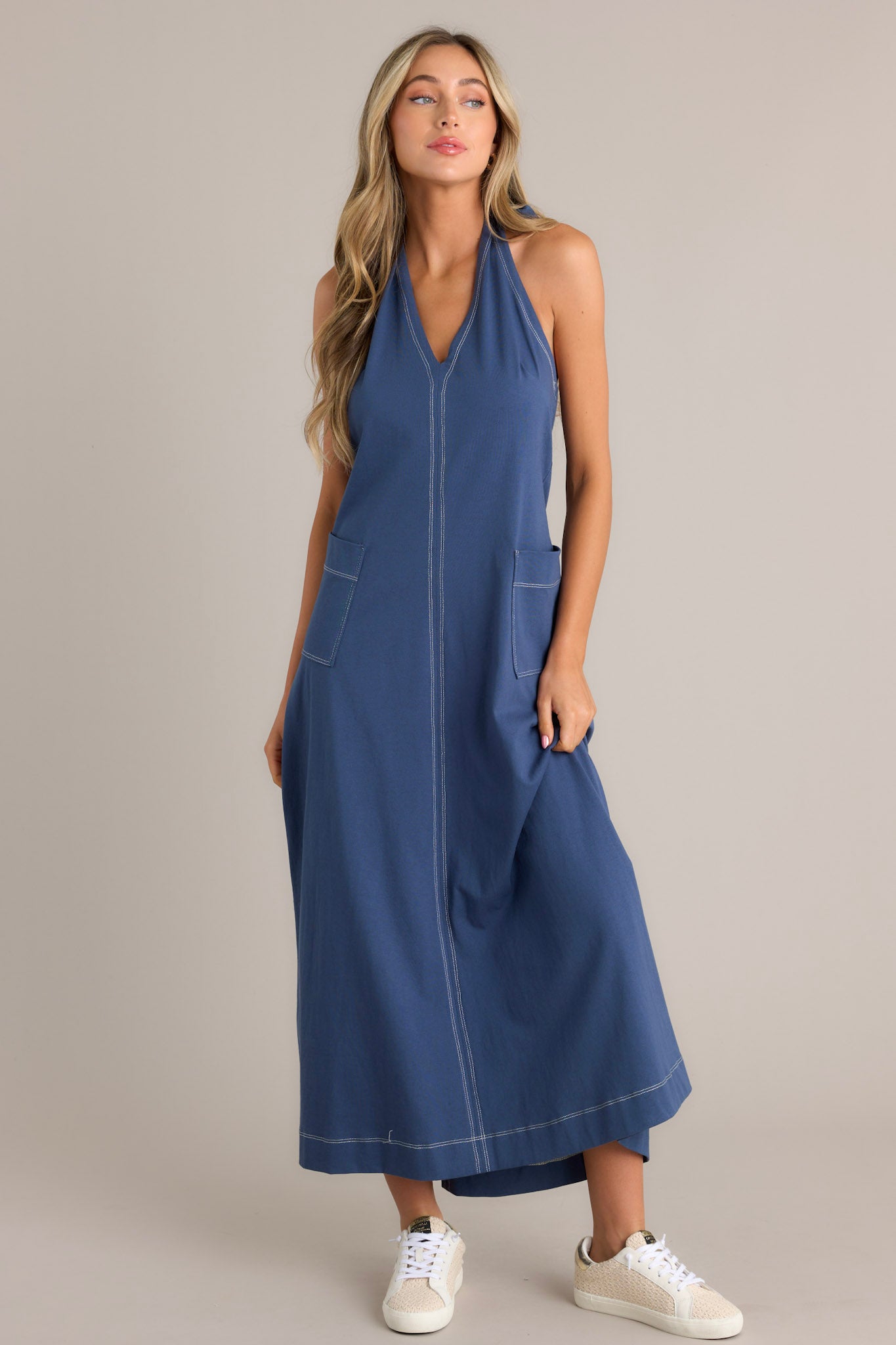 Casual blue maxi dress with contrast stitching, V-neck, and large front pockets.