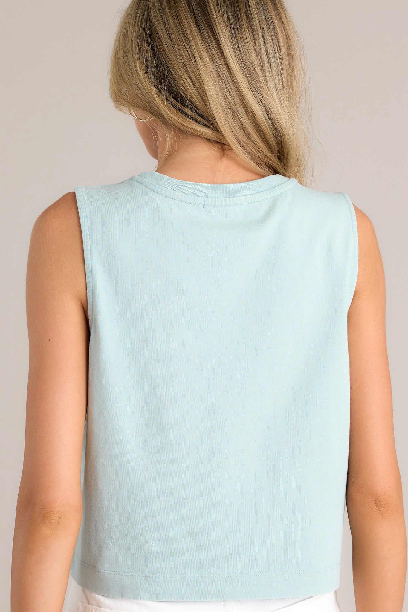 Back view of a harbor gray jersey tank featuring a high back, wide sleeves, and a cropped design.