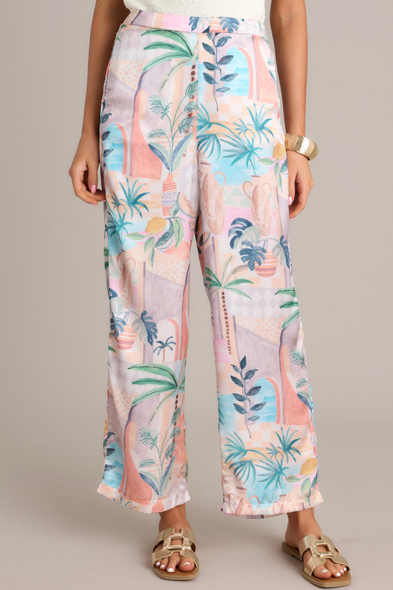 These peach pants feature a high waisted design, an elastic insert in the back of the waist, functional hip pockets, a lightweight fabric, and a wide leg.