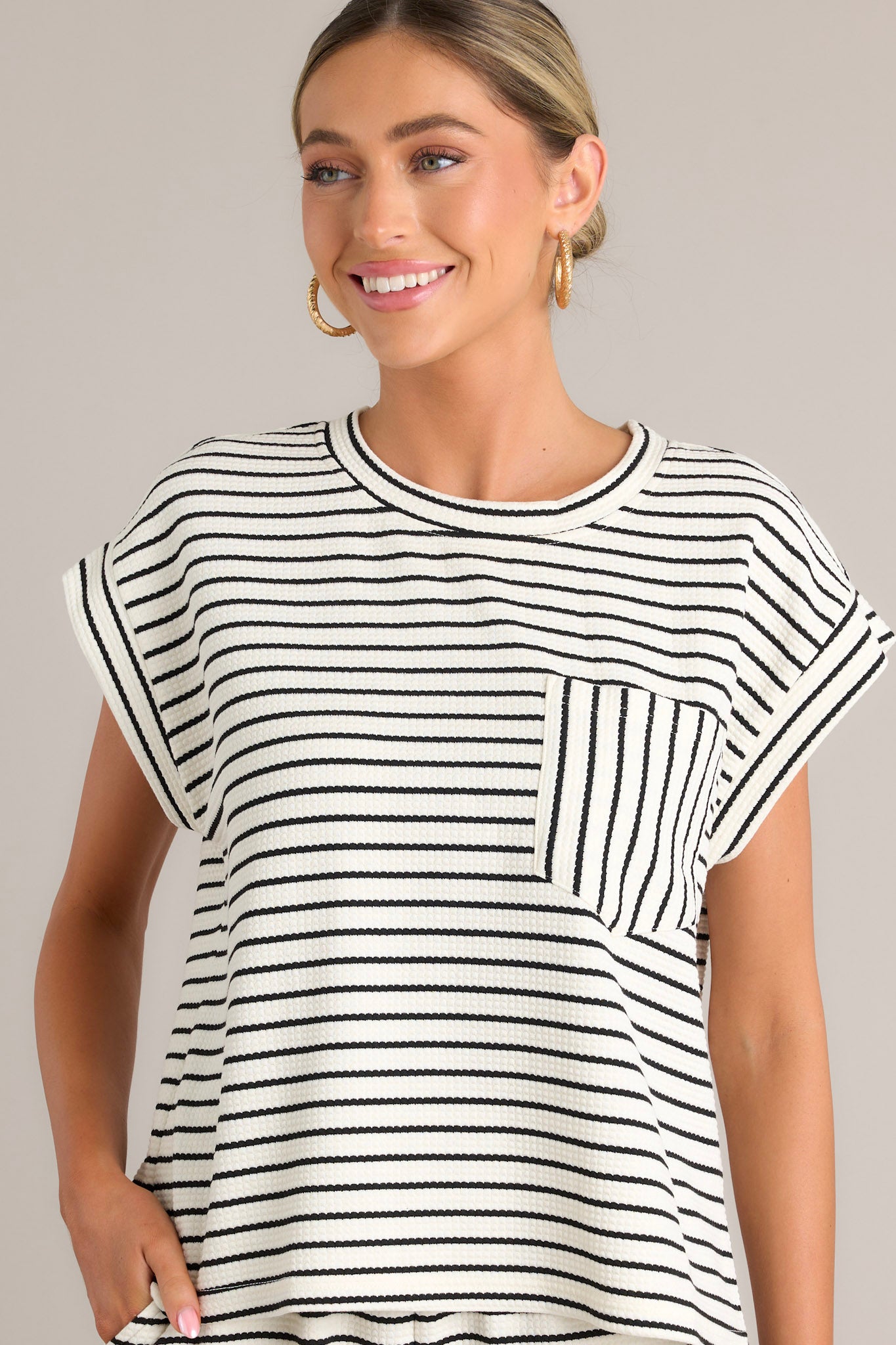 Front view of the striped top highlighting the horizontal stripe pattern and wide cuffed sleeves.