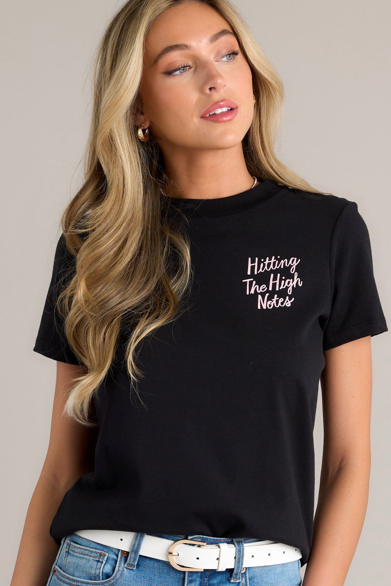 This black tee features a crew neckline, graphics on the front and back, short sleeves, and a relaxed fit.