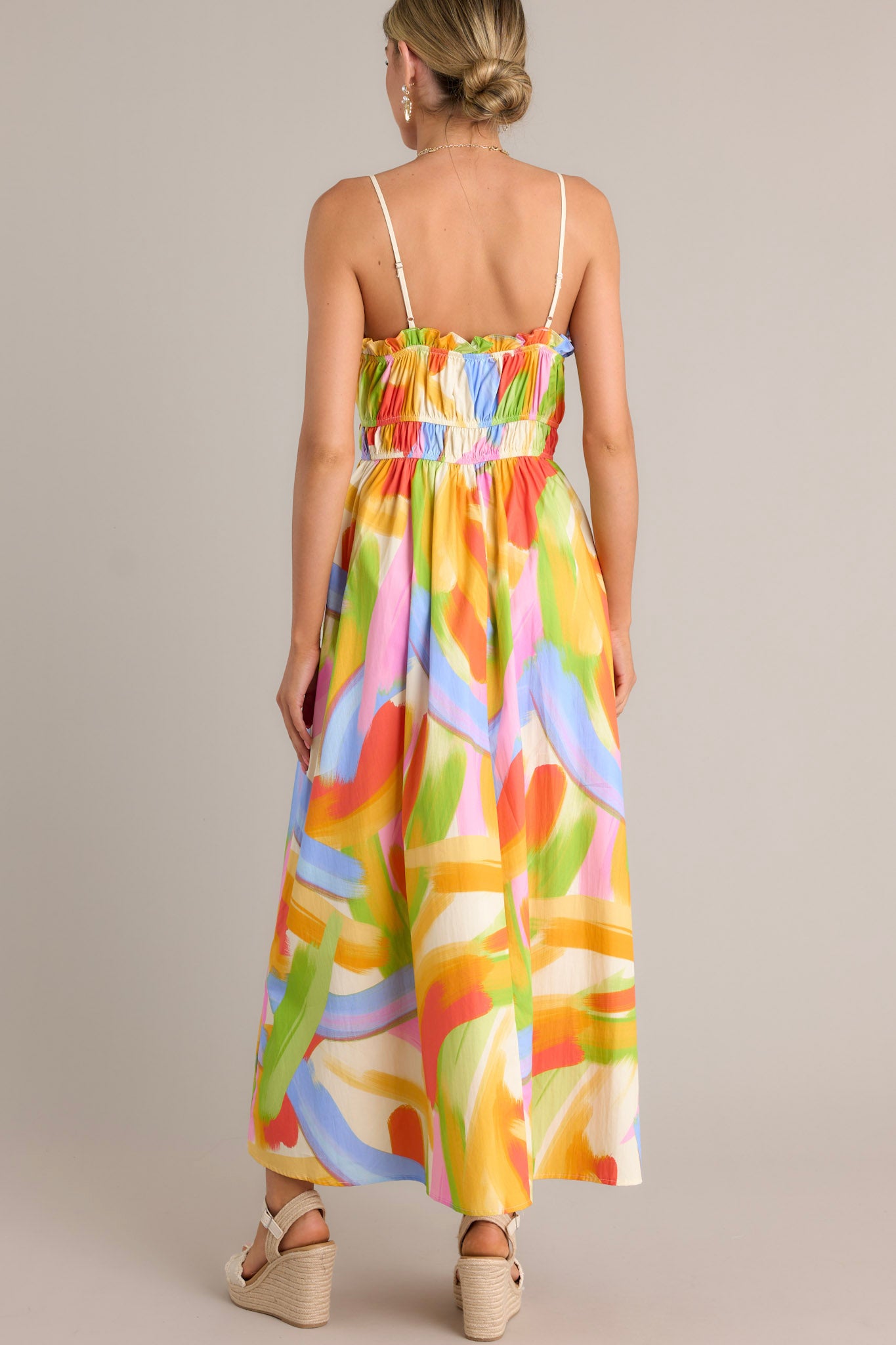 Close-up of the yellow multi maxi dress showing the square neckline, pleated chest, and functional hip pockets.