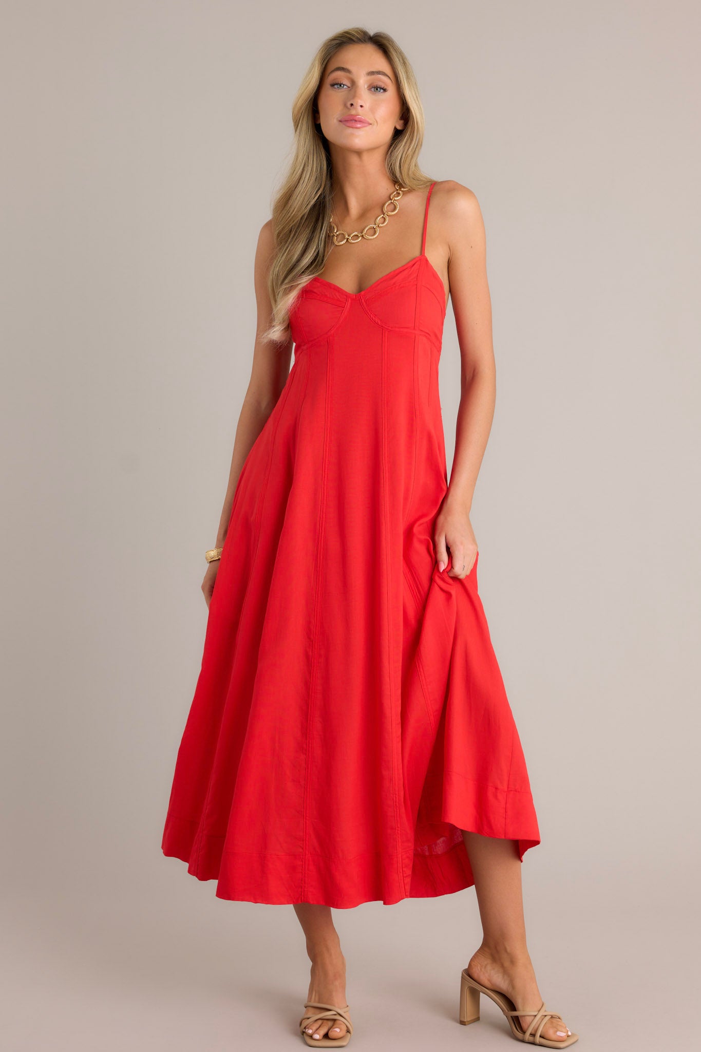 This red maxi dress features a sweetheart neckline, thin adjustable straps, no boning in the bodice (while still keeping the bustier look), a smocked back insert, a discrete zipper, and a flowing silhouette.