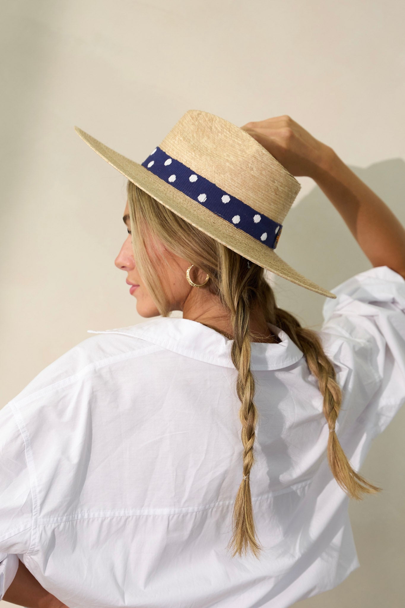 This Wendy hat features a navy, cotton woven band with white polka dots.