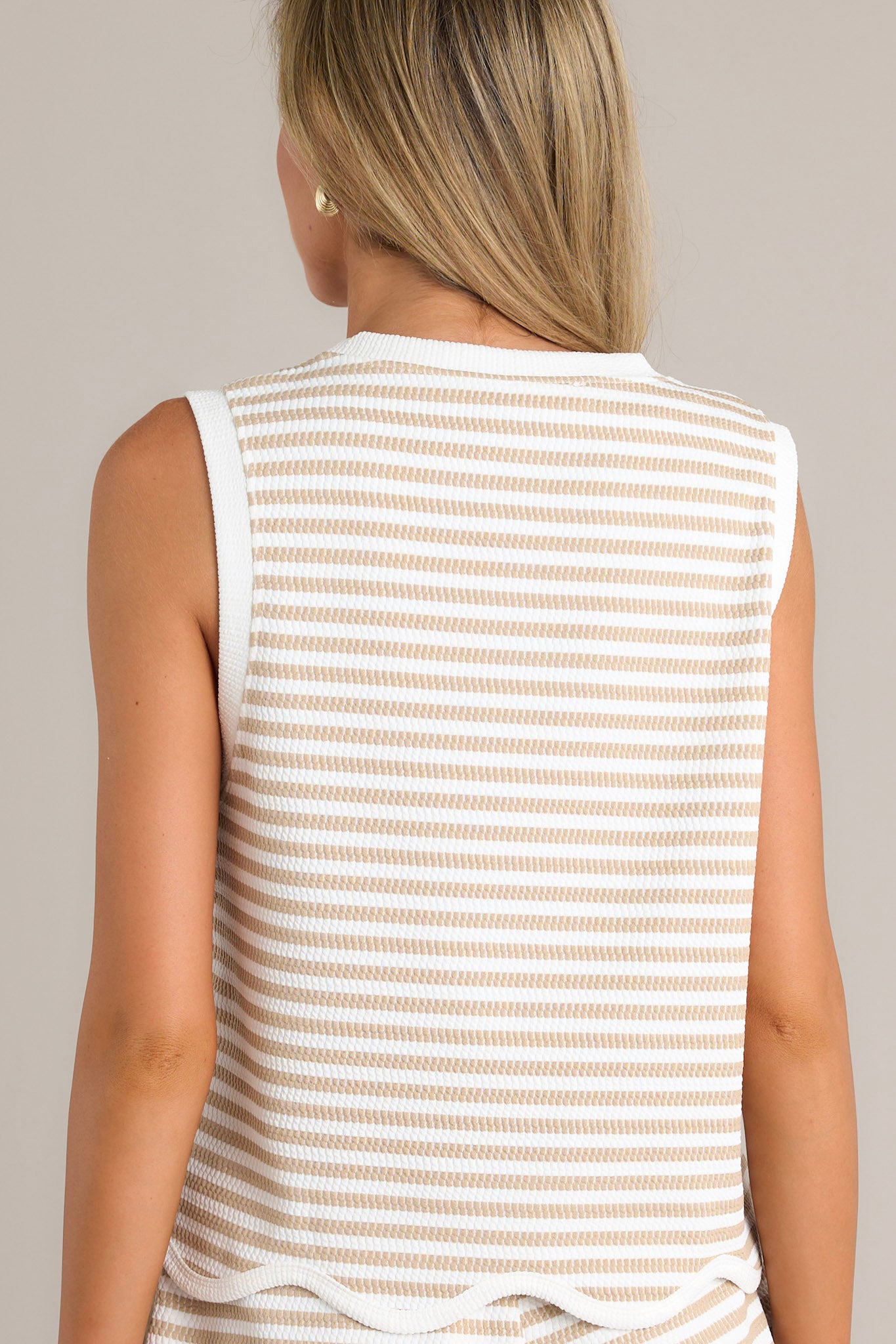 Back view of a stripe tank top highlighting the ribbed texture and overall fit.