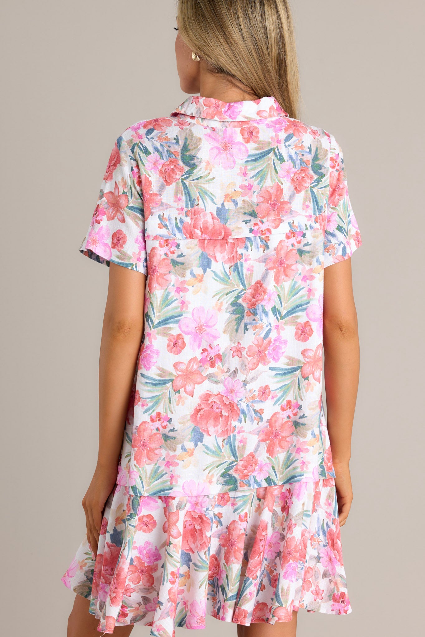 Back view of a floral mini dress highlighting the single tier and the relaxed fit.