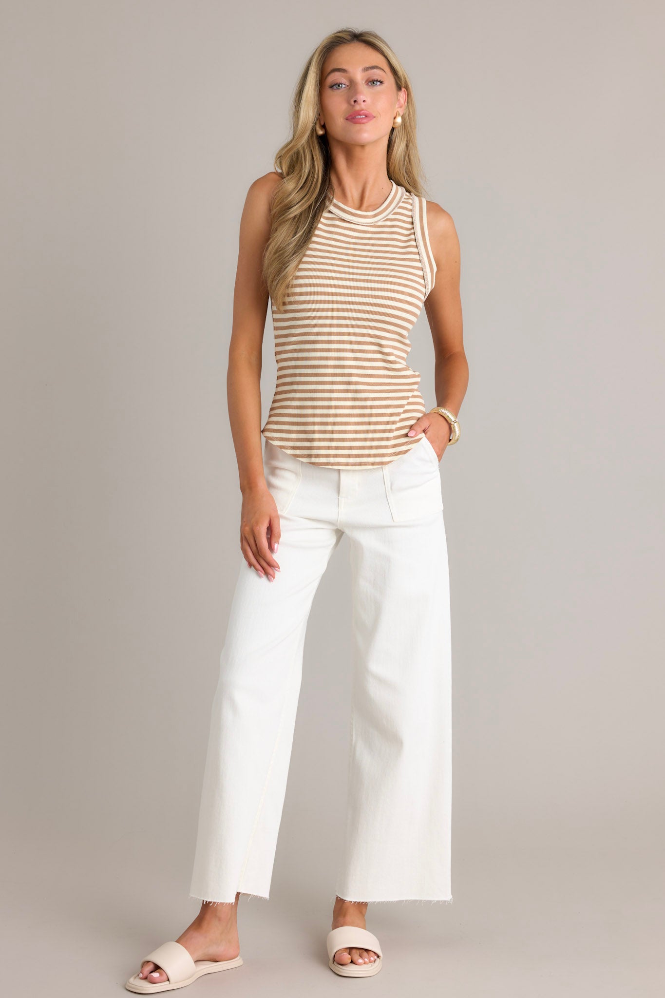 Full length view of this tank that features a ribbed scoop neckline, a classic stripe pattern, a ribbed texture, and a scoop hemline.