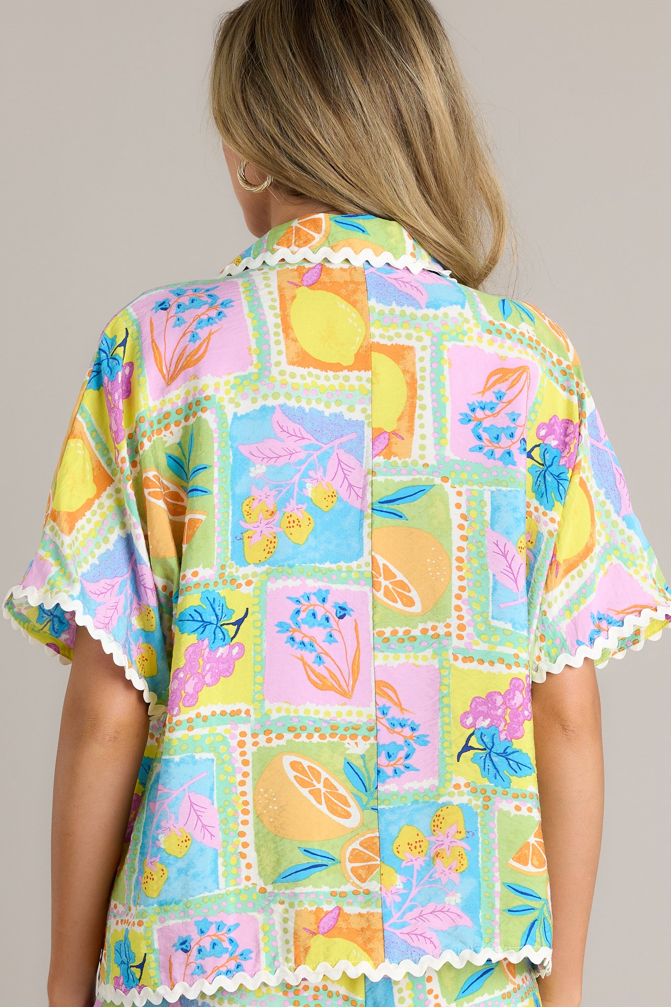 Back view of a tropical ricrac top highlighting the unique print, contrasting ricrac trim, and overall fit.