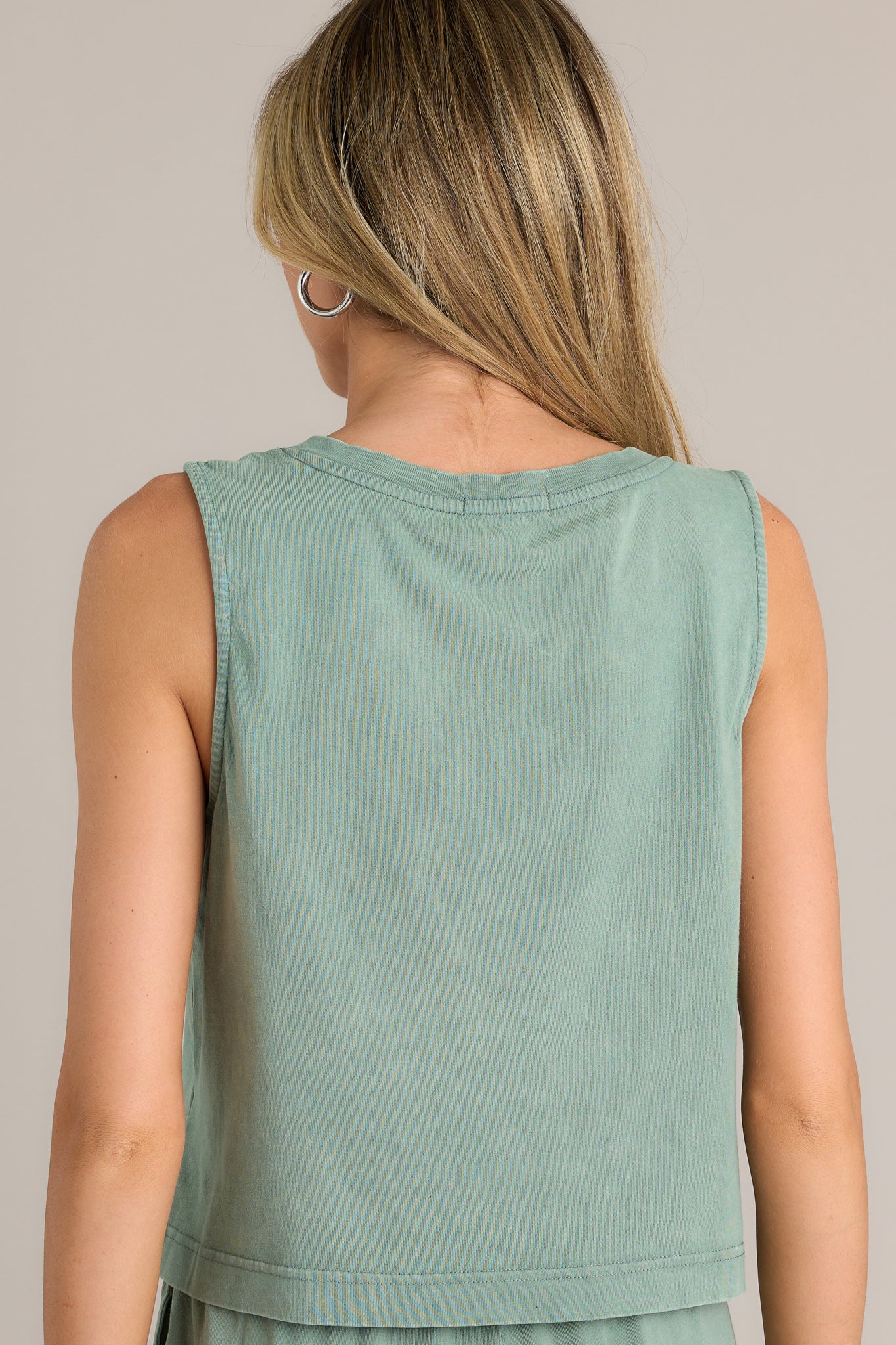 Back view of a palm green tank highlighting the overall fit and slightly cropped hemline.