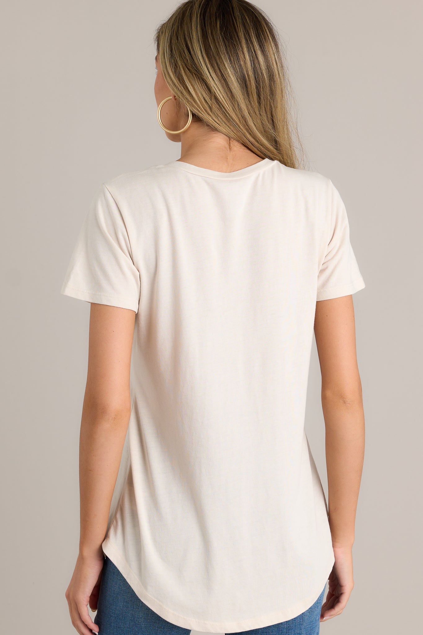 Back view of a tee highlighting the overall fit, scooped hemline, and short sleeves.