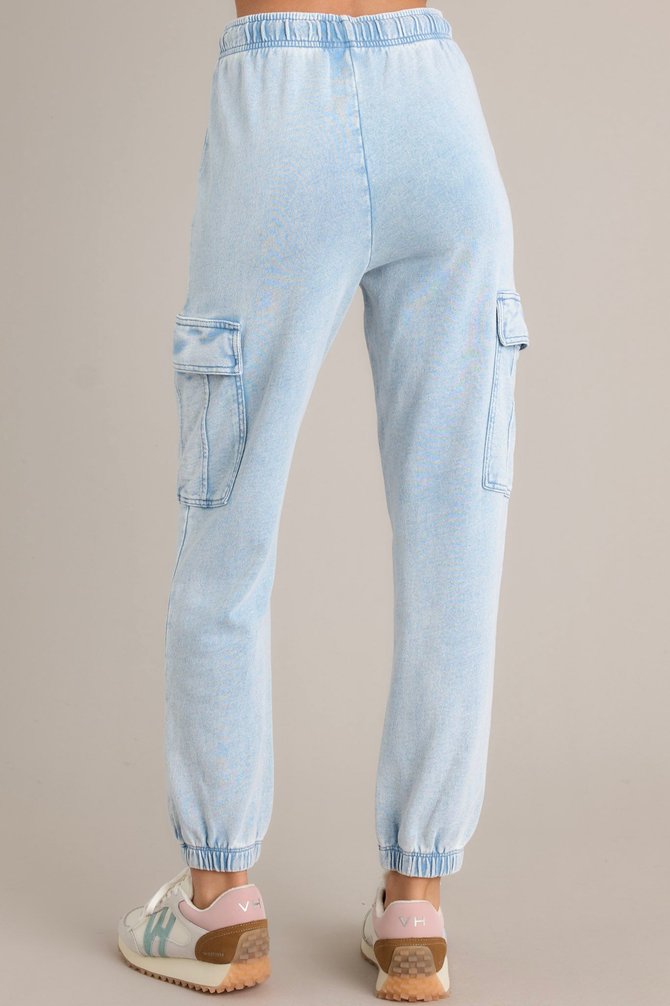 Back view of these joggers that feature an elastic waistband with a self-tie drawstring, large side pockets, a washed design, and elastic cuffed ankles.