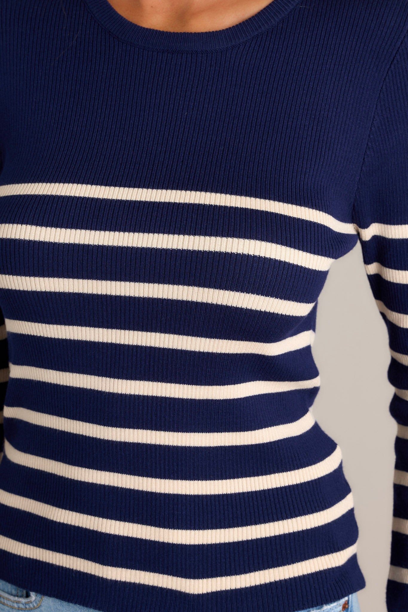 Close-up of the beige stripe navy top showing the crew neckline, stretchy ribbed fabric, and striped pattern.