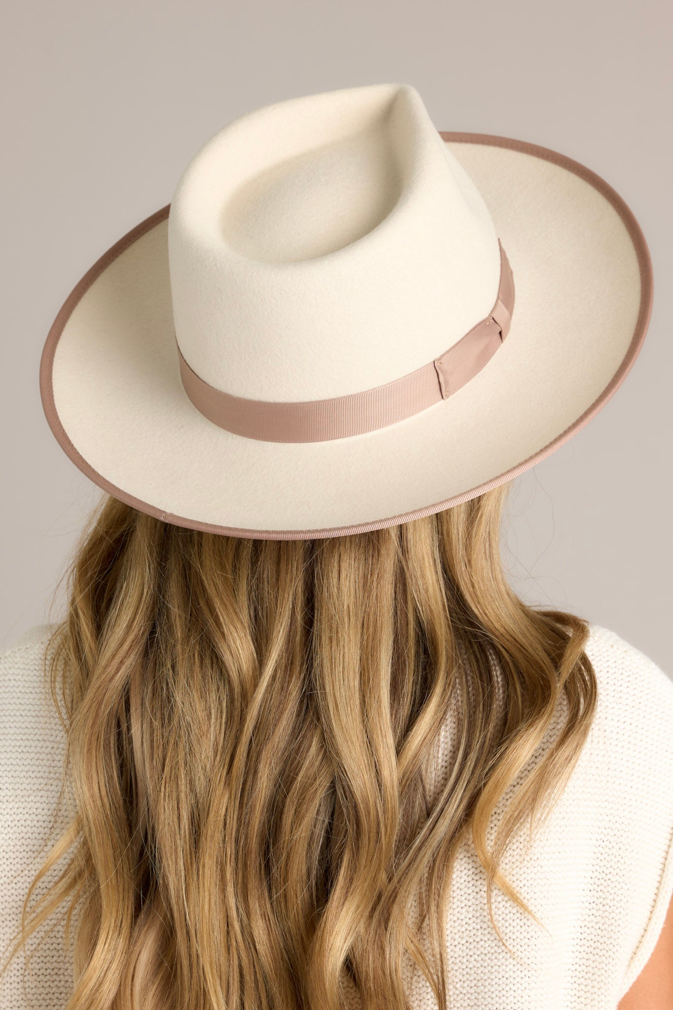 Back view of this hat that features a teardrop crown with a stiff upturned brim and a band around the crown.