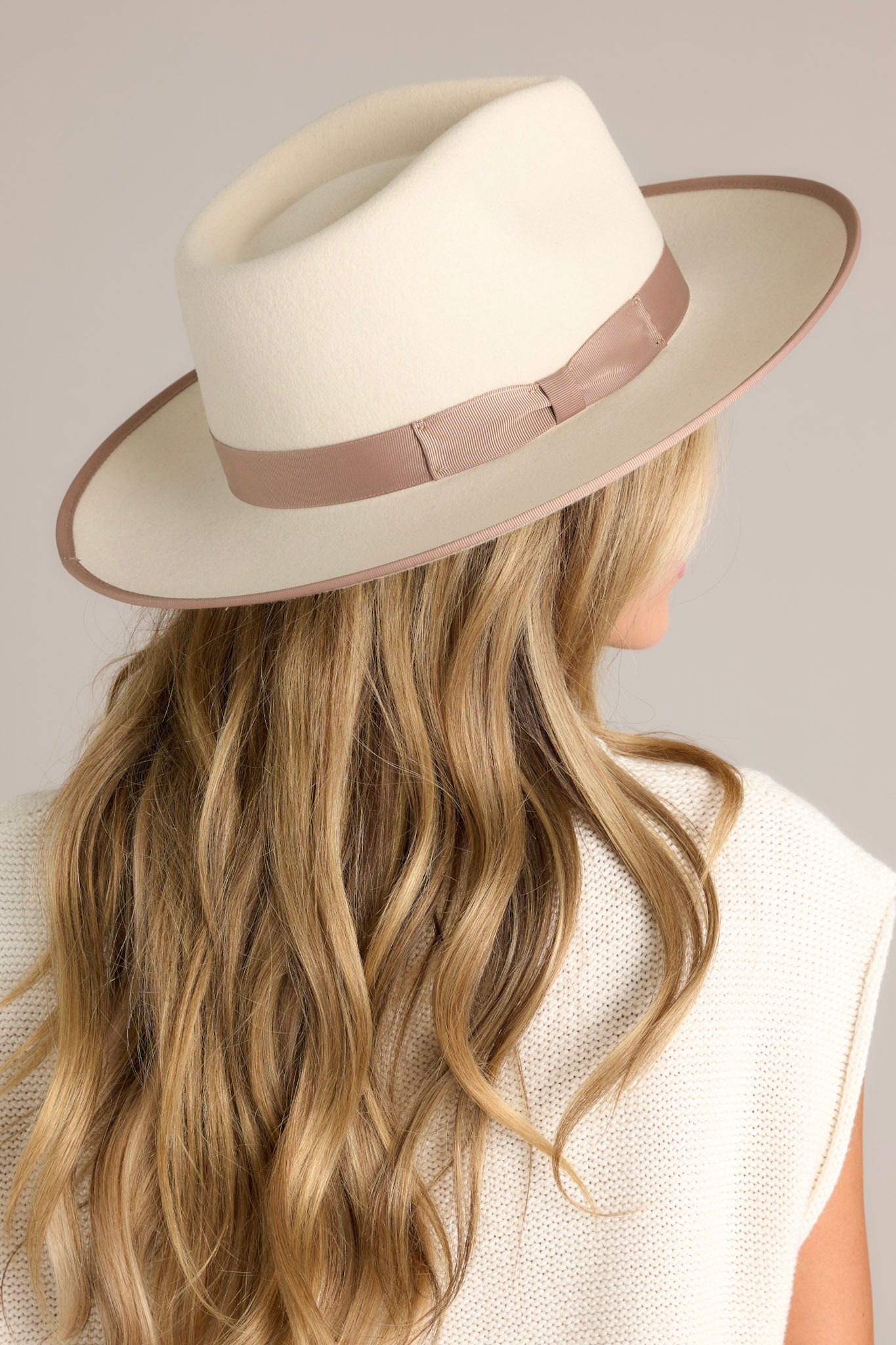 Angled Back view of this hat that features a teardrop crown with a stiff upturned brim and a band around the crown.